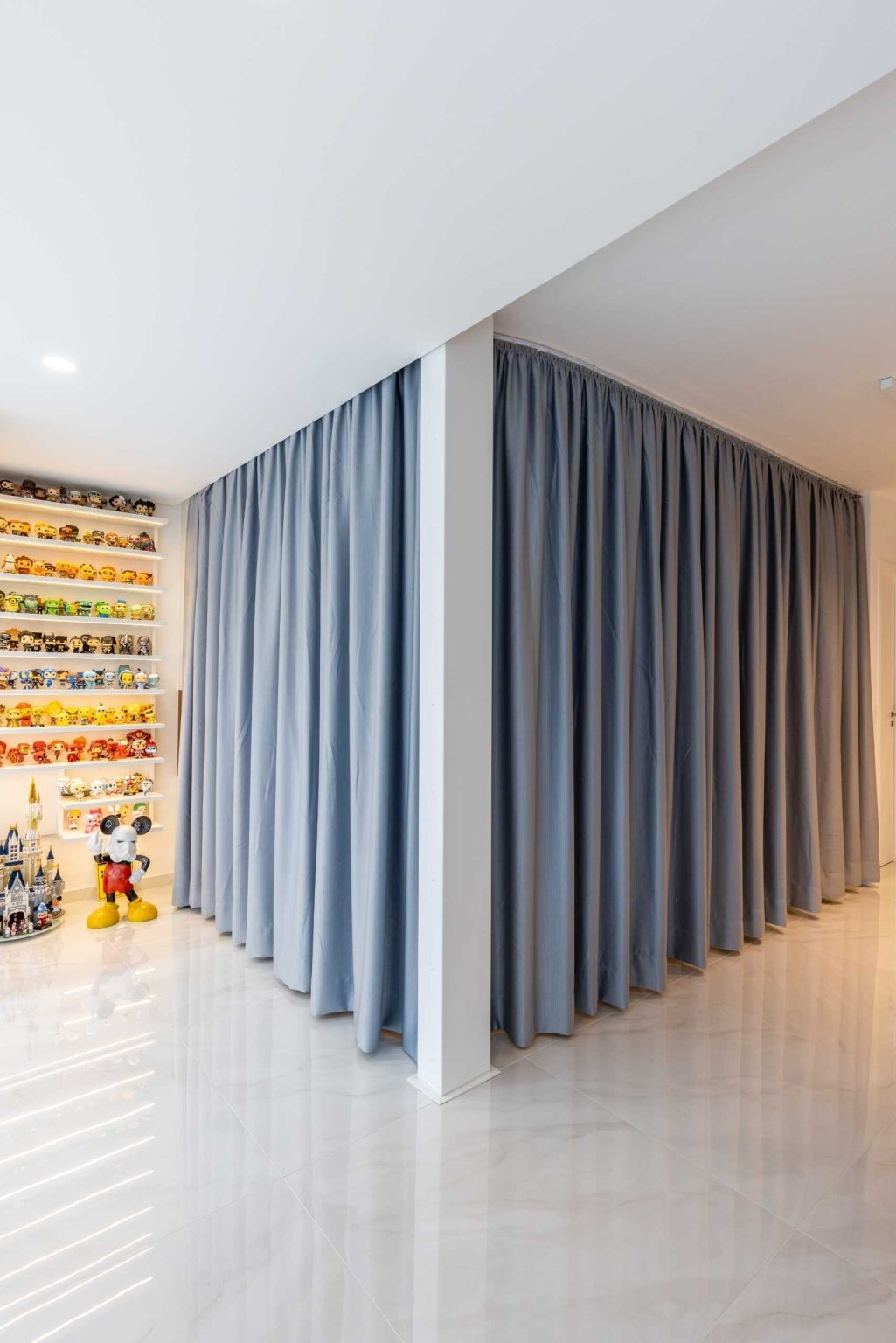 These floor-to-ceiling bedroom curtains can hide an entire sleeping area in seconds. A smart design idea that adds privacy without closing off the apartment.
