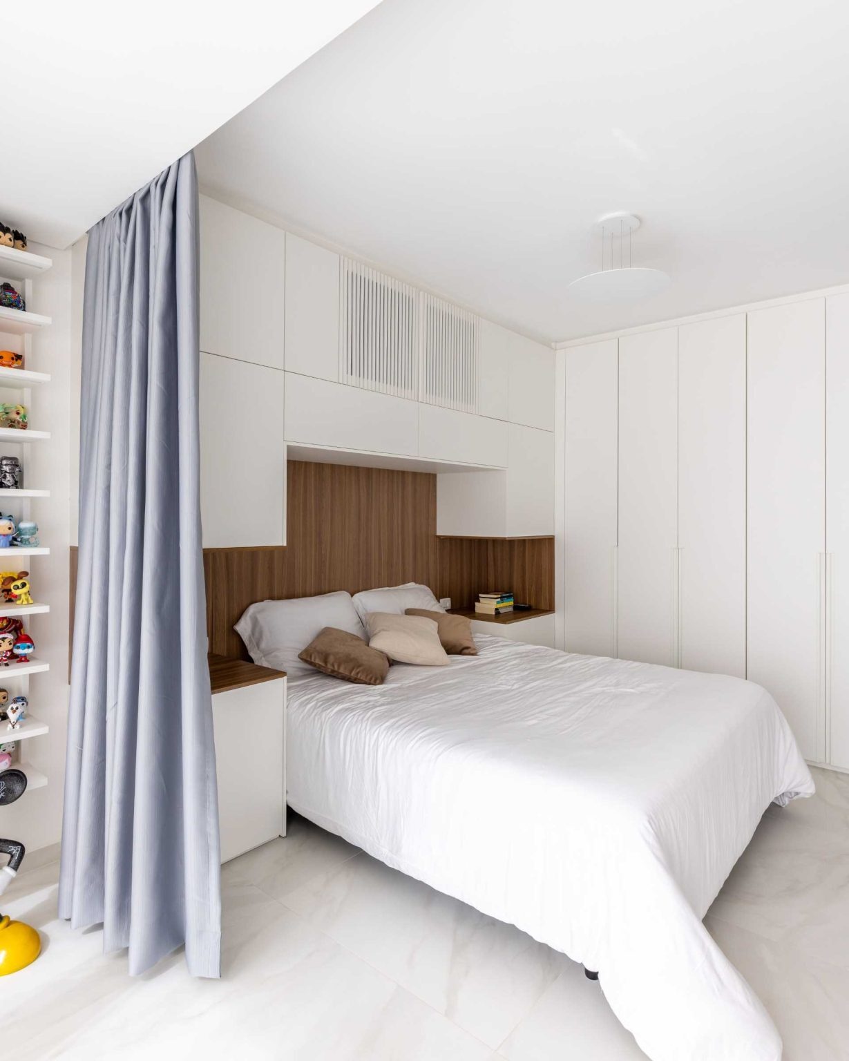 Hidden lighting, built-in storage, and integrated bedside tables make this compact bedroom feel organized and inviting without wasting space.
