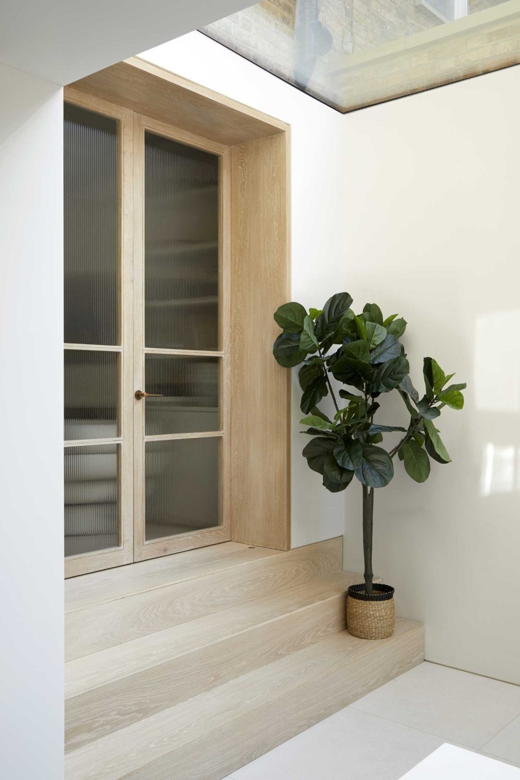 A wood-framed doorway links the bright contemporary extension to the original Victorian interiors, creating a beautiful contrast between old and new.