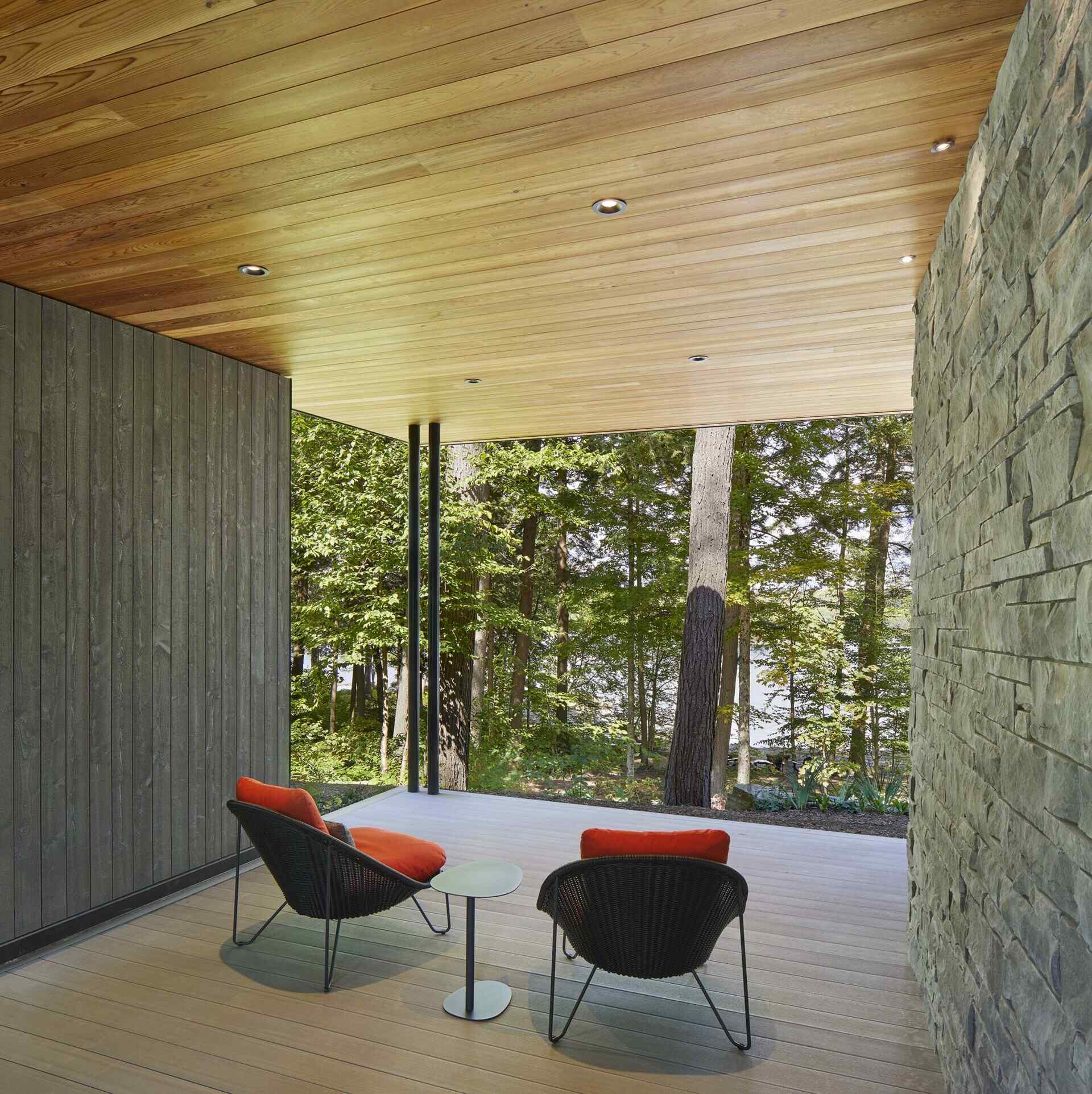 Generous roof overhangs extend outward from the central volume, forming an additional outdoor area, and helping separate the primary suite from the rest of the home.