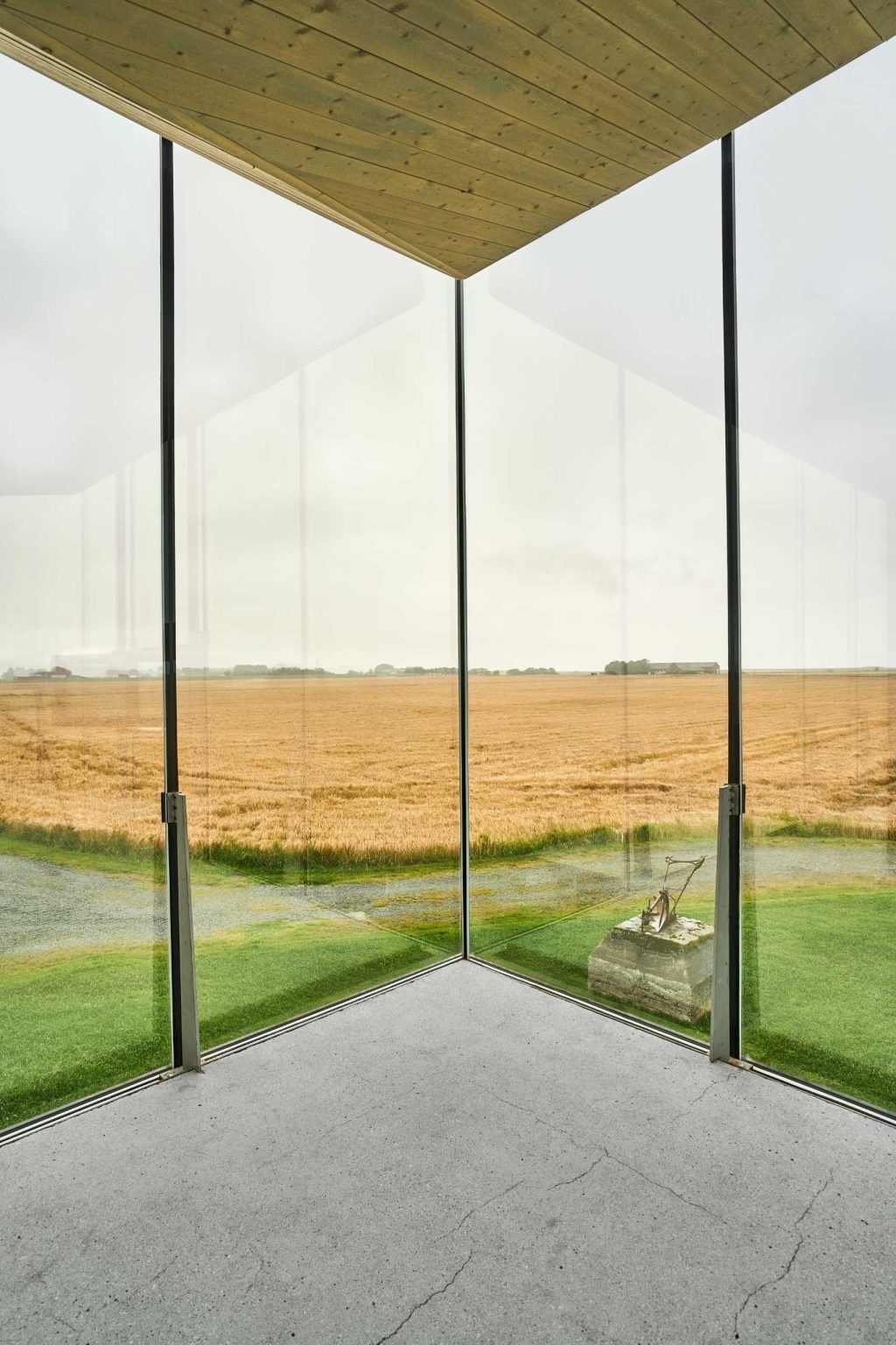Floor-to-ceiling glass wraps this Norwegian pavilion with panoramic views, while steel, concrete, wood, and glass create a contemporary interior.