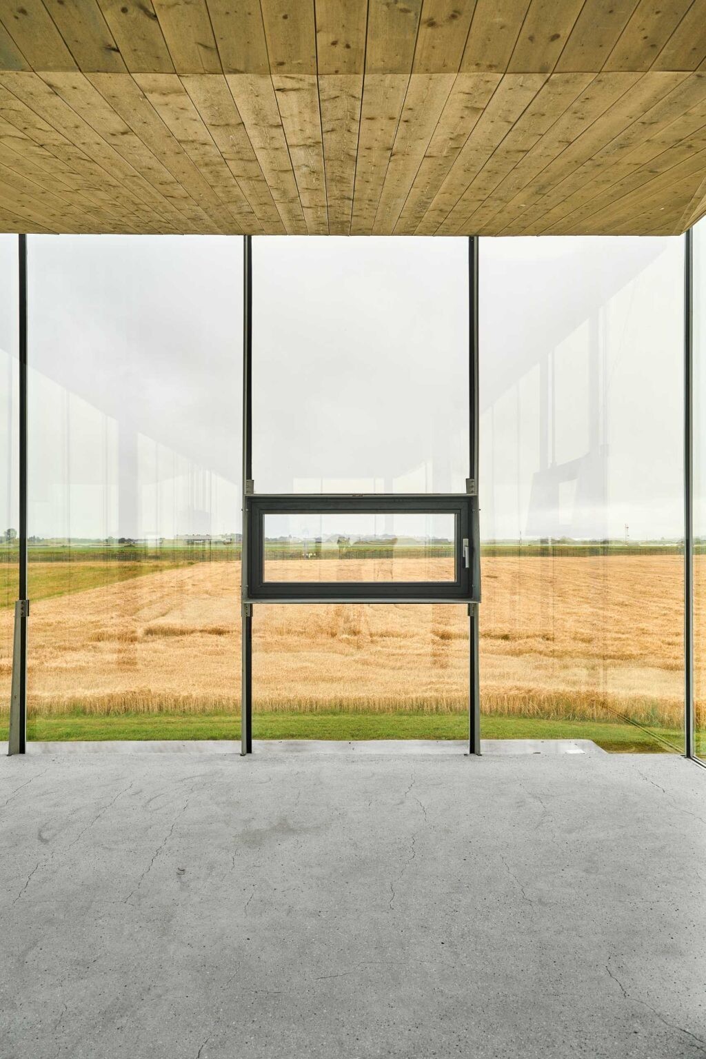 Floor-to-ceiling glass wraps this Norwegian pavilion with panoramic views, while steel, concrete, wood, and glass create a contemporary interior.