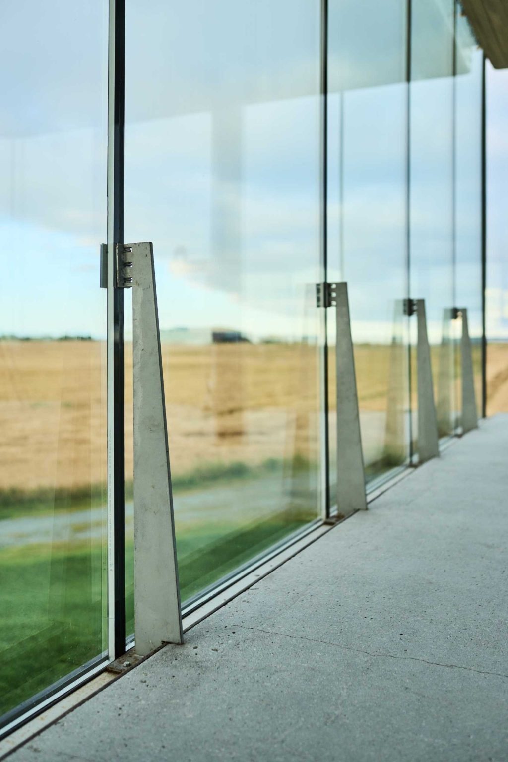 Floor-to-ceiling glass wraps this Norwegian pavilion with panoramic views, while steel, concrete, wood, and glass create a contemporary interior.