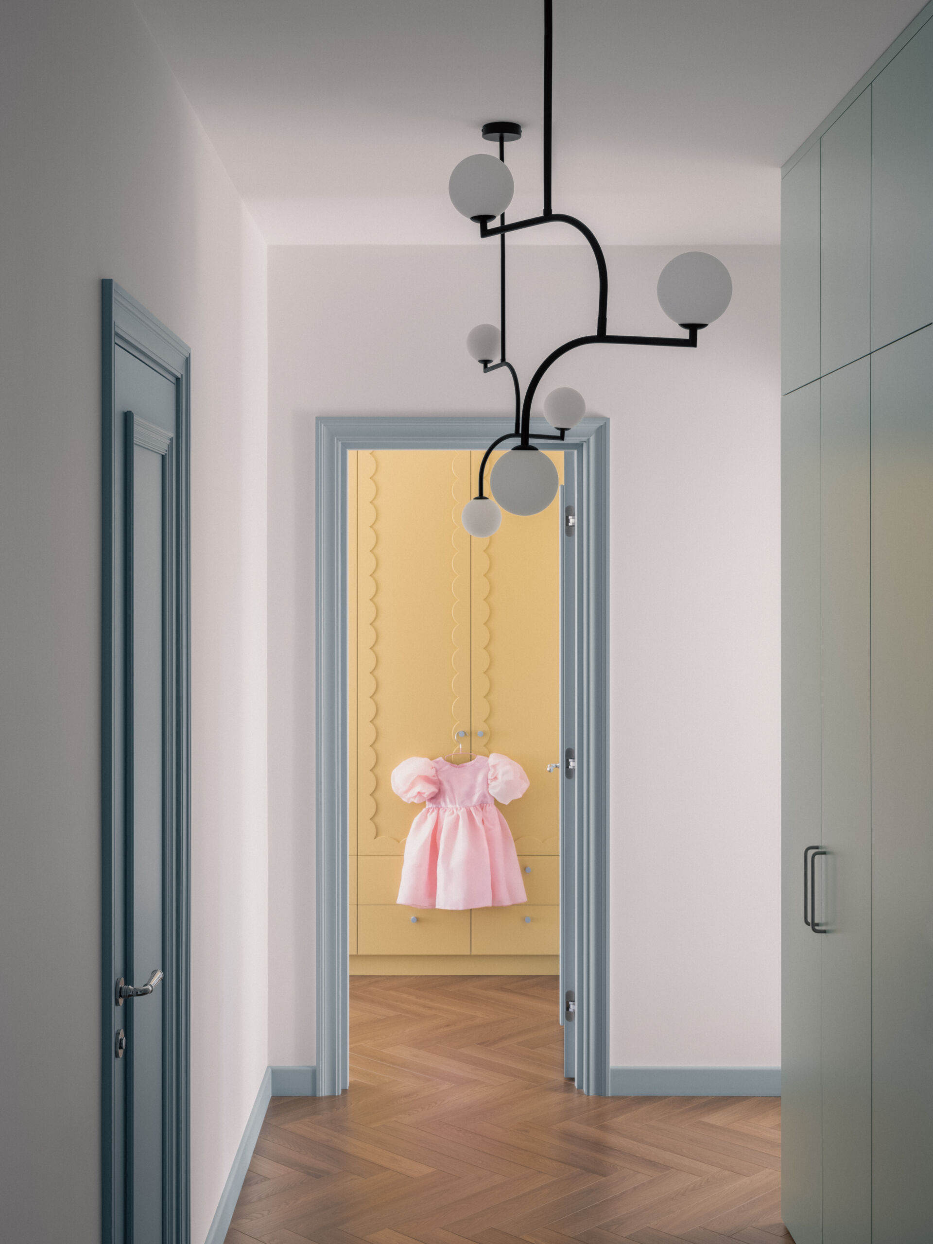 In this children's bedroom for three, colorful yellow cabinets with fun detailing line the wall and at the same time complement the built-in desk underneath the window. Nearby a single bed and a bunk bed provides plenty of space for the children to each have their own area.