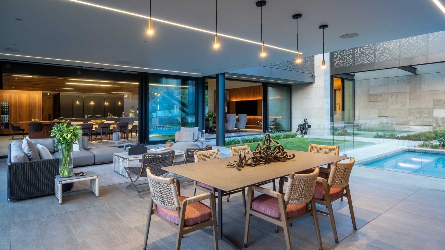 A swimming pool, fire pit, water feature, and shaded lanai create an outdoor entertaining area designed for relaxing and gathering with family and friends.