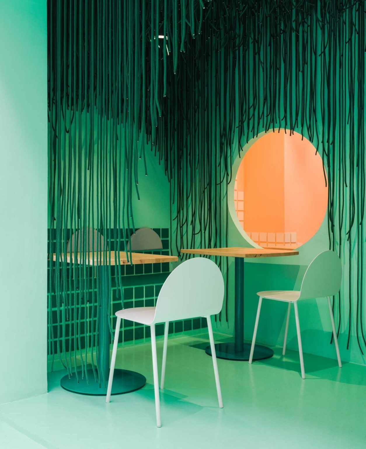 A light green facade and hundreds of hanging ropes create the first chapter of Baovan's immersive design story in Valencia. Designed by Clap Studio, the entrance transforms into a forest-like installation that draws visitors into the restaurant experience before they even step inside.