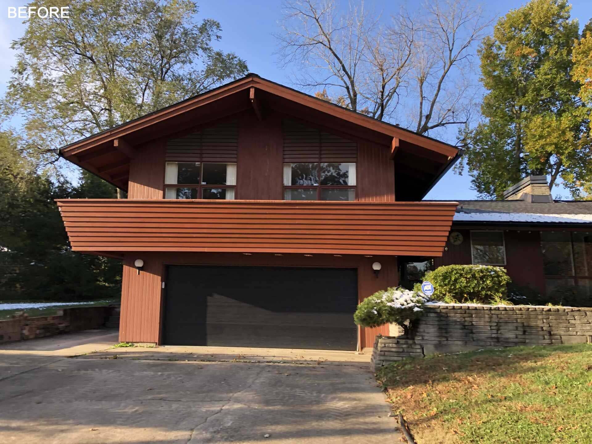 BEFORE - This Kansas City renovation begins with a striking dark exterior and a welcoming rear patio. Floor-to-ceiling windows connect indoor and outdoor spaces while highlighting the home's original mid-century architecture.