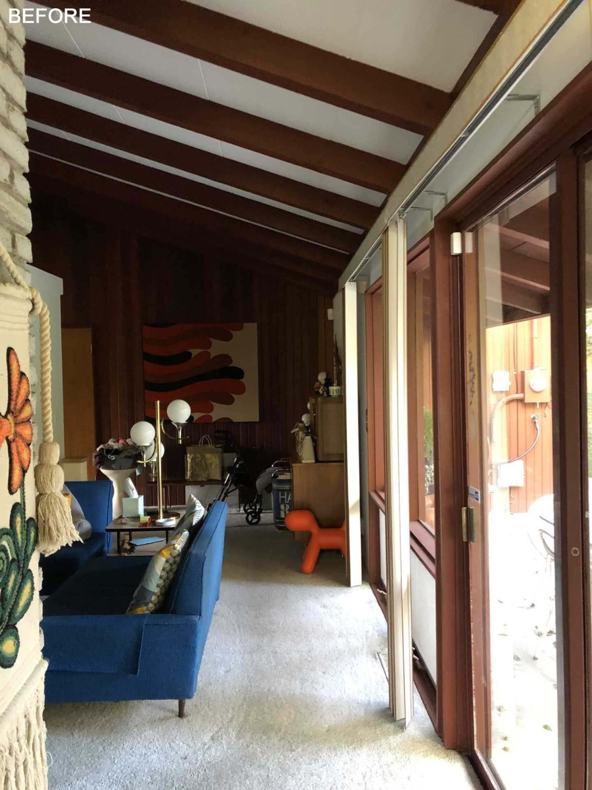 BEFORE - An original living room becomes a bright dining space centered around a preserved double-sided brick fireplace. Open views and mid-century furnishings help connect the home's updated interiors.