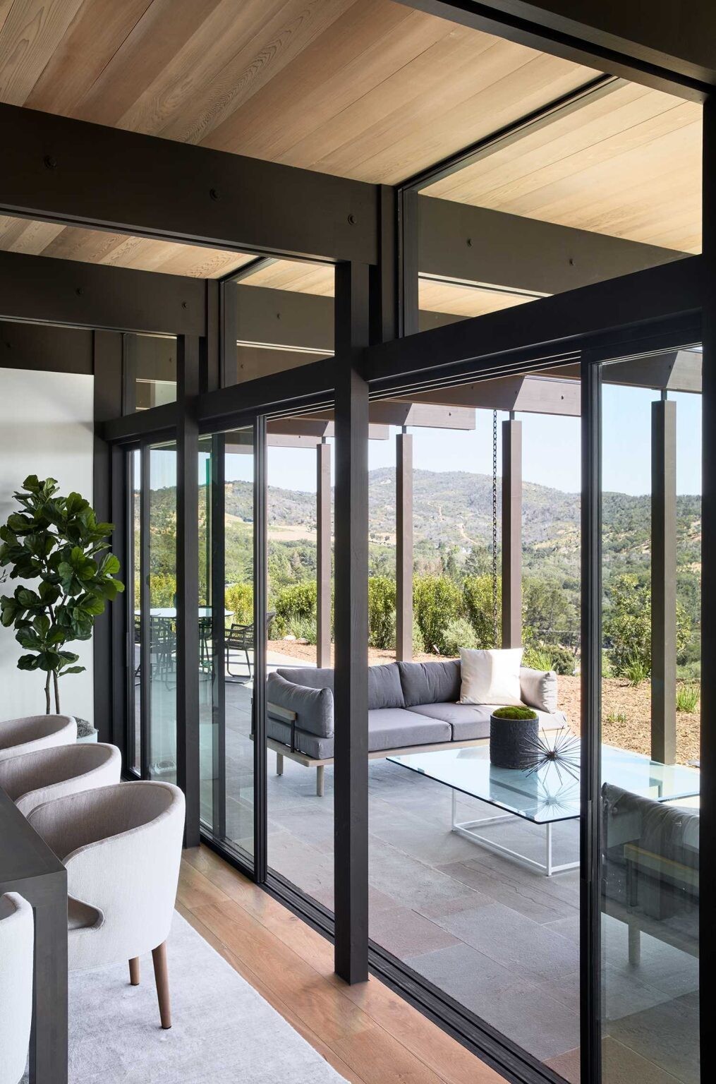 Exposed post and beam construction adds architectural character to the open-plan dining and living areas overlooking Sonoma Valley.