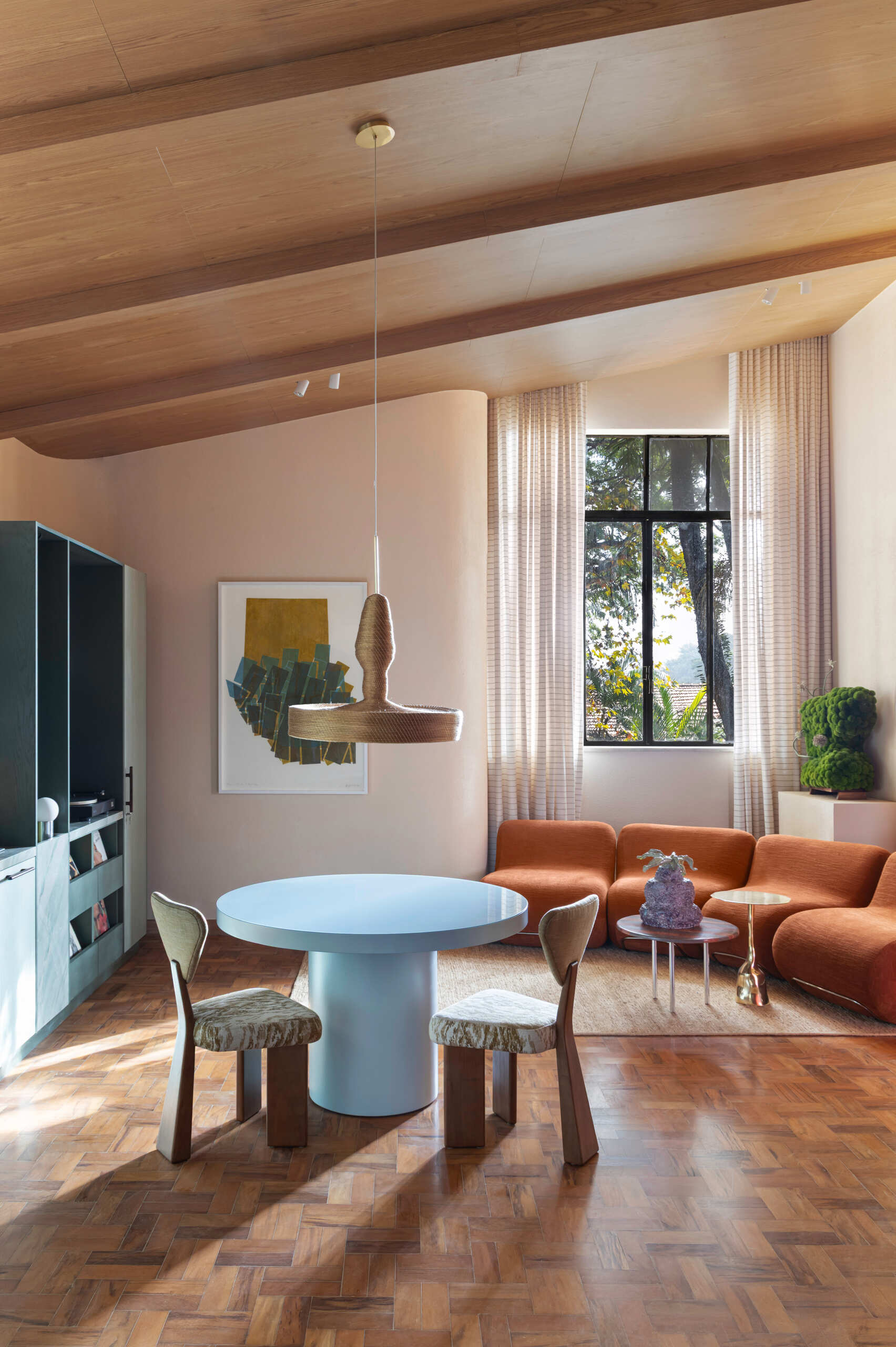 Organic furniture, artful styling, and a vinyl-focused layout create a living room designed around conversation and connection.