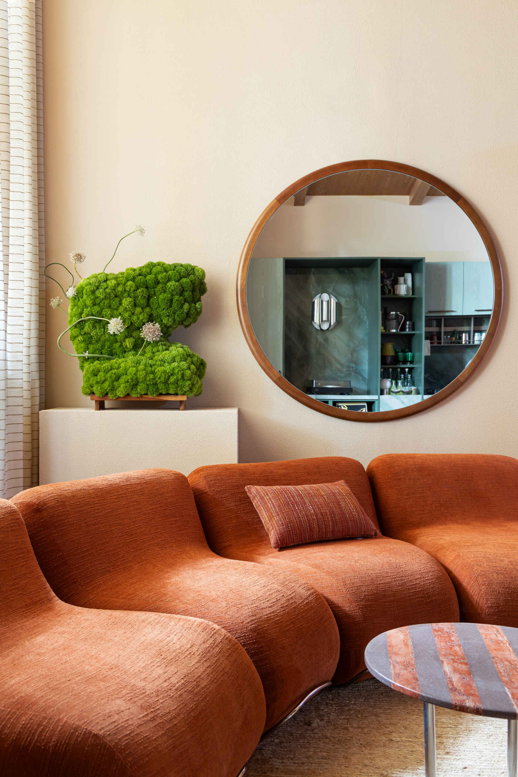 Organic furniture, artful styling, and a vinyl-focused layout create a living room designed around conversation and connection.
