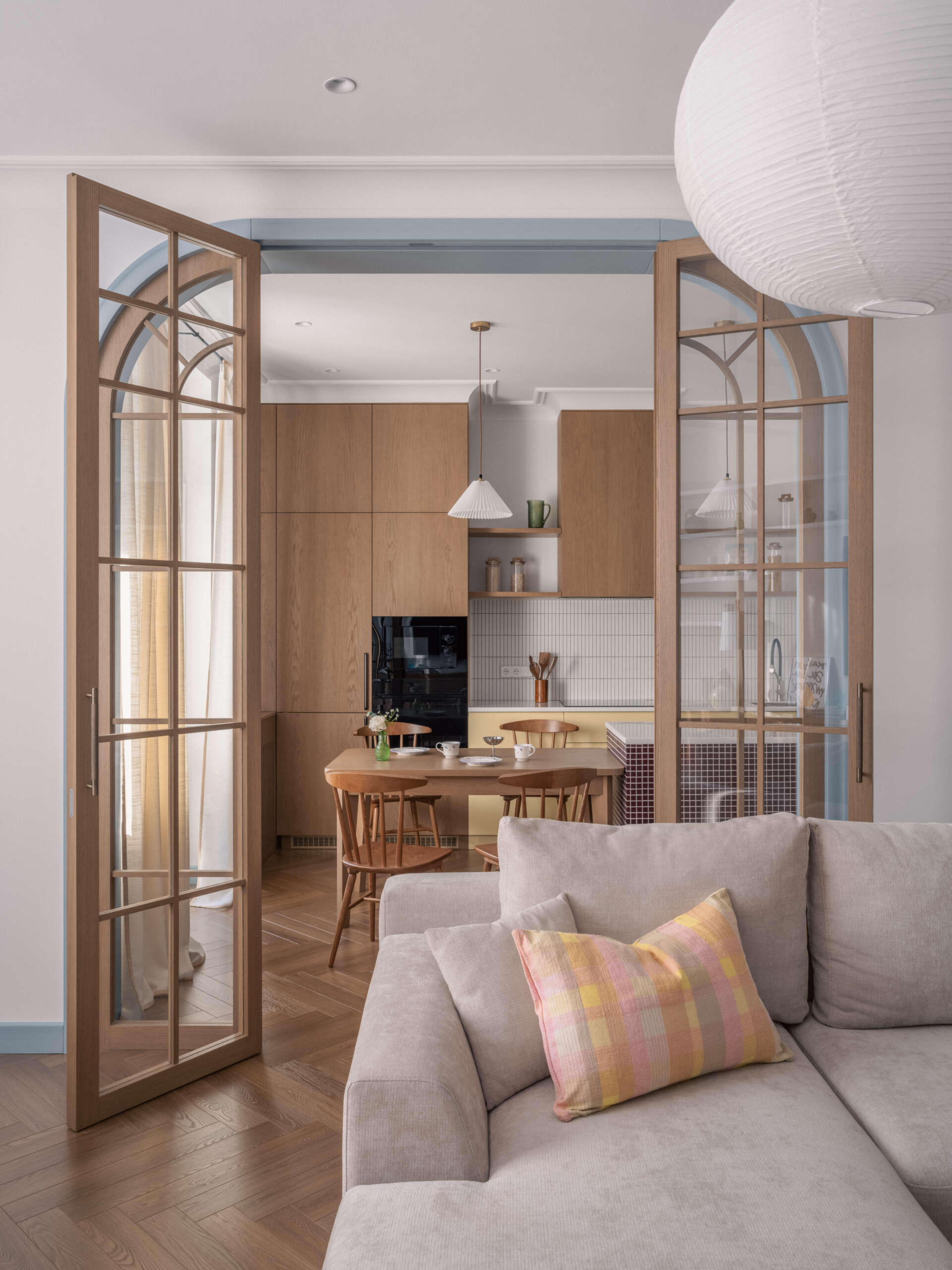 An arched doorway adds architectural character and softness, creating a beautiful transition between rooms while enhancing the apartment's flow.