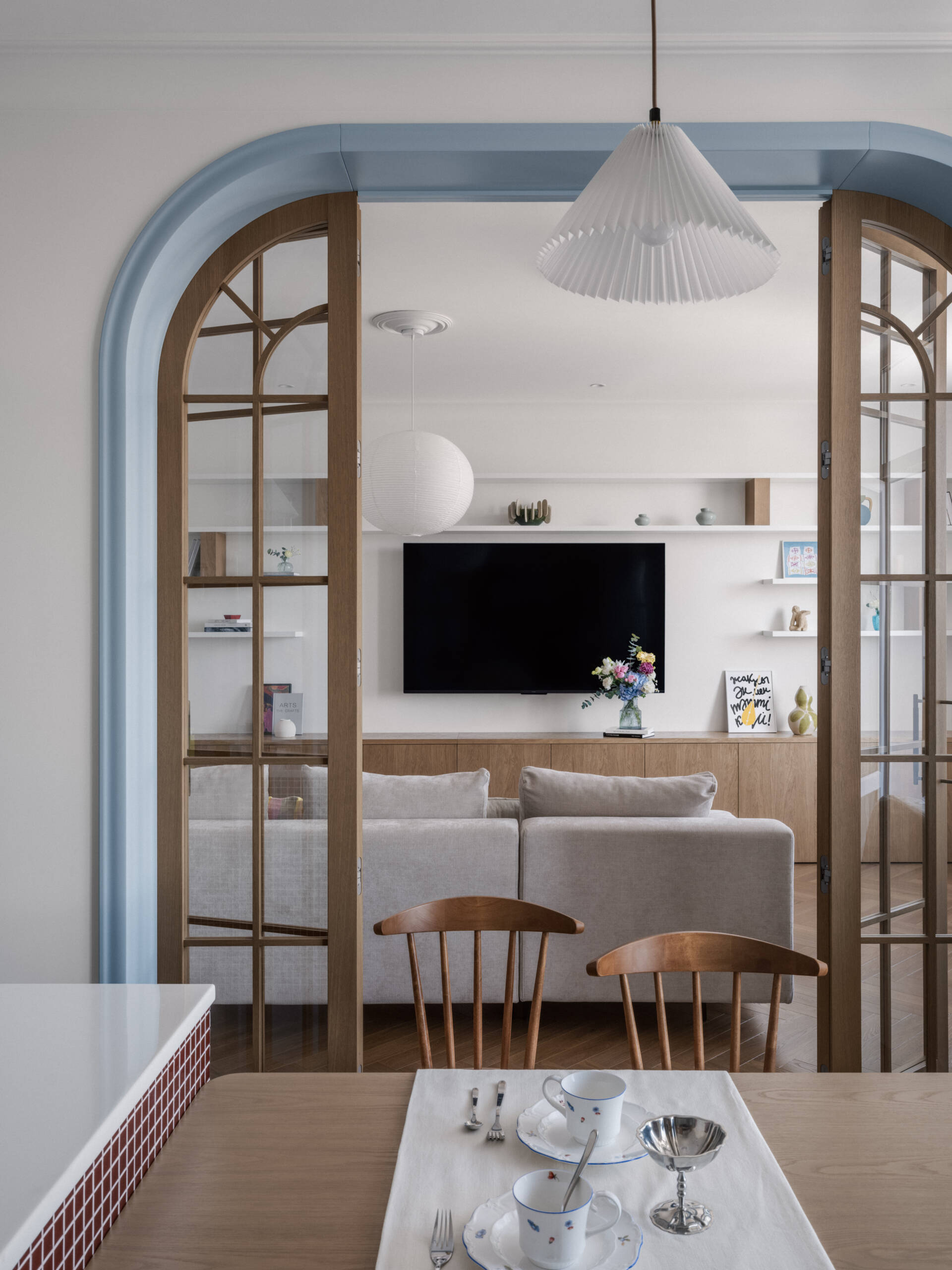 An arched doorway adds architectural character and softness, creating a beautiful transition between rooms while enhancing the apartment's flow.