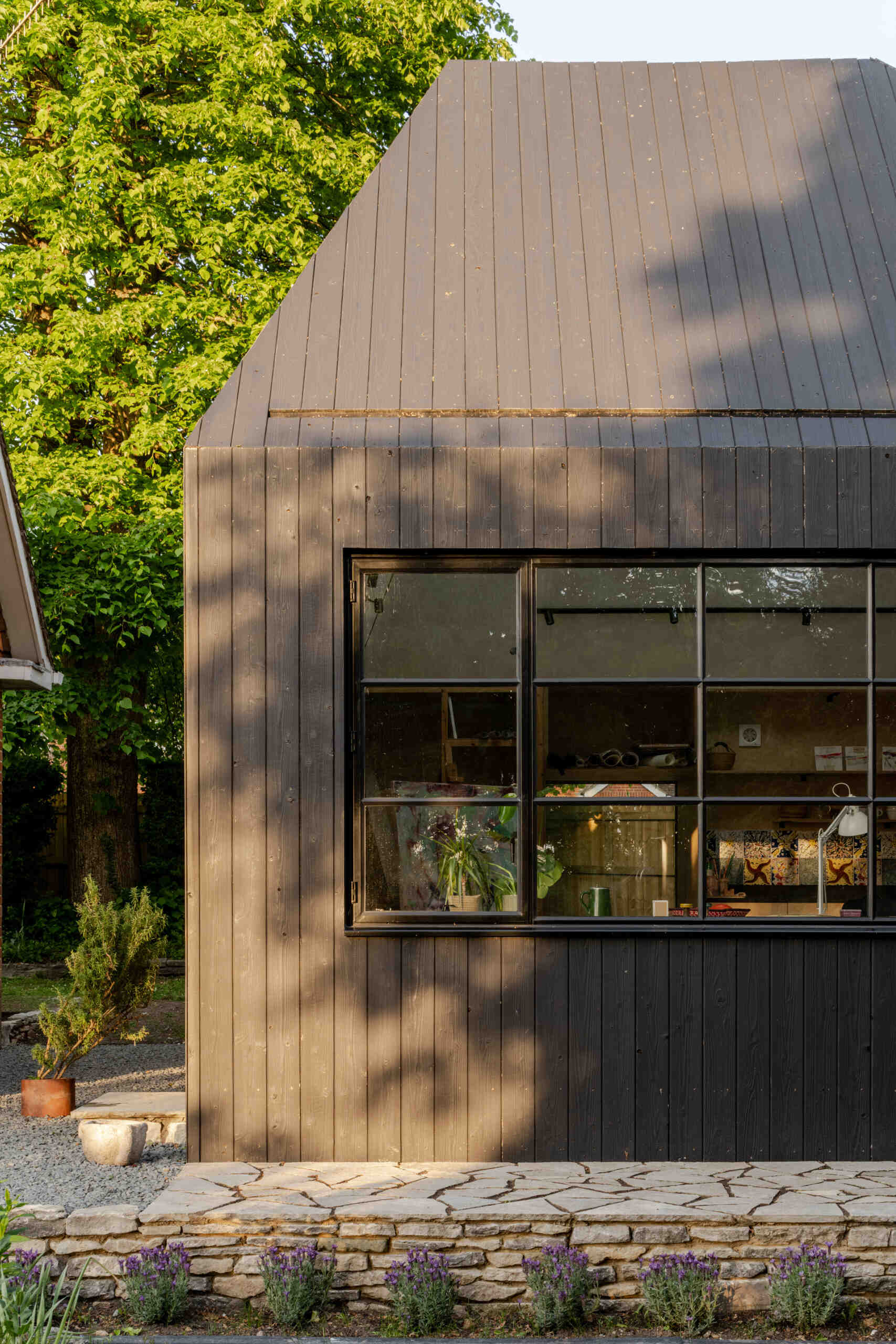 Hidden within a garden near Salisbury, this art studio features charred timber cladding, high-performance SIP construction, natural daylight, and low-impact foundations.