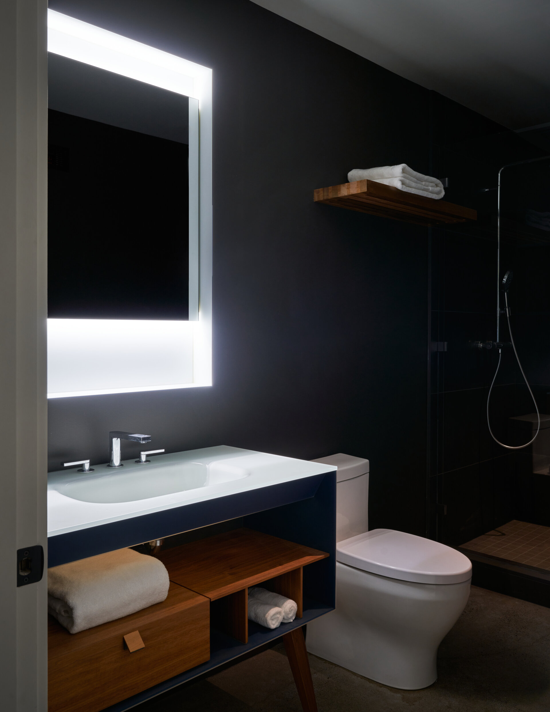 A modern bathroom with dark walls.
