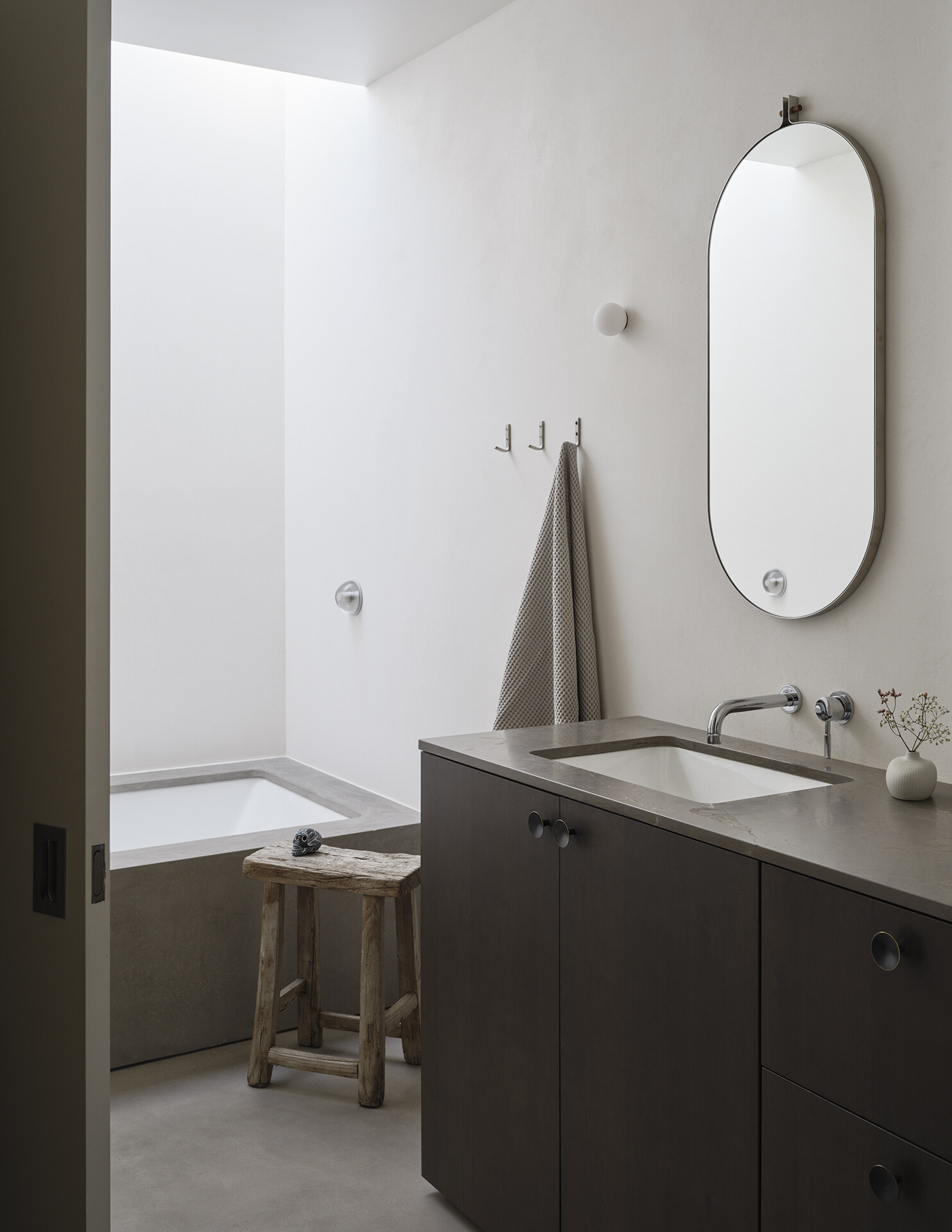 A built-in bathtub and walk-in shower bring comfort and simplicity to this bright upstairs bathroom.
