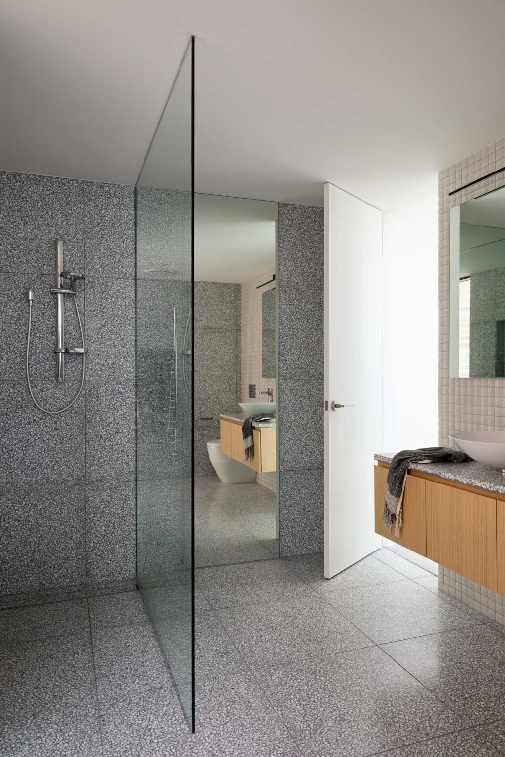 A floating timber vanity, freestanding bathtub and walk-in shower give this contemporary bathroom a warm and elegant feel.