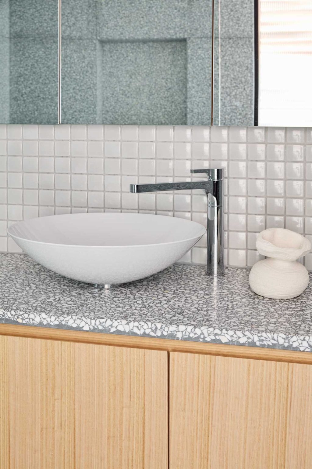 A floating timber vanity, freestanding bathtub and walk-in shower give this contemporary bathroom a warm and elegant feel.