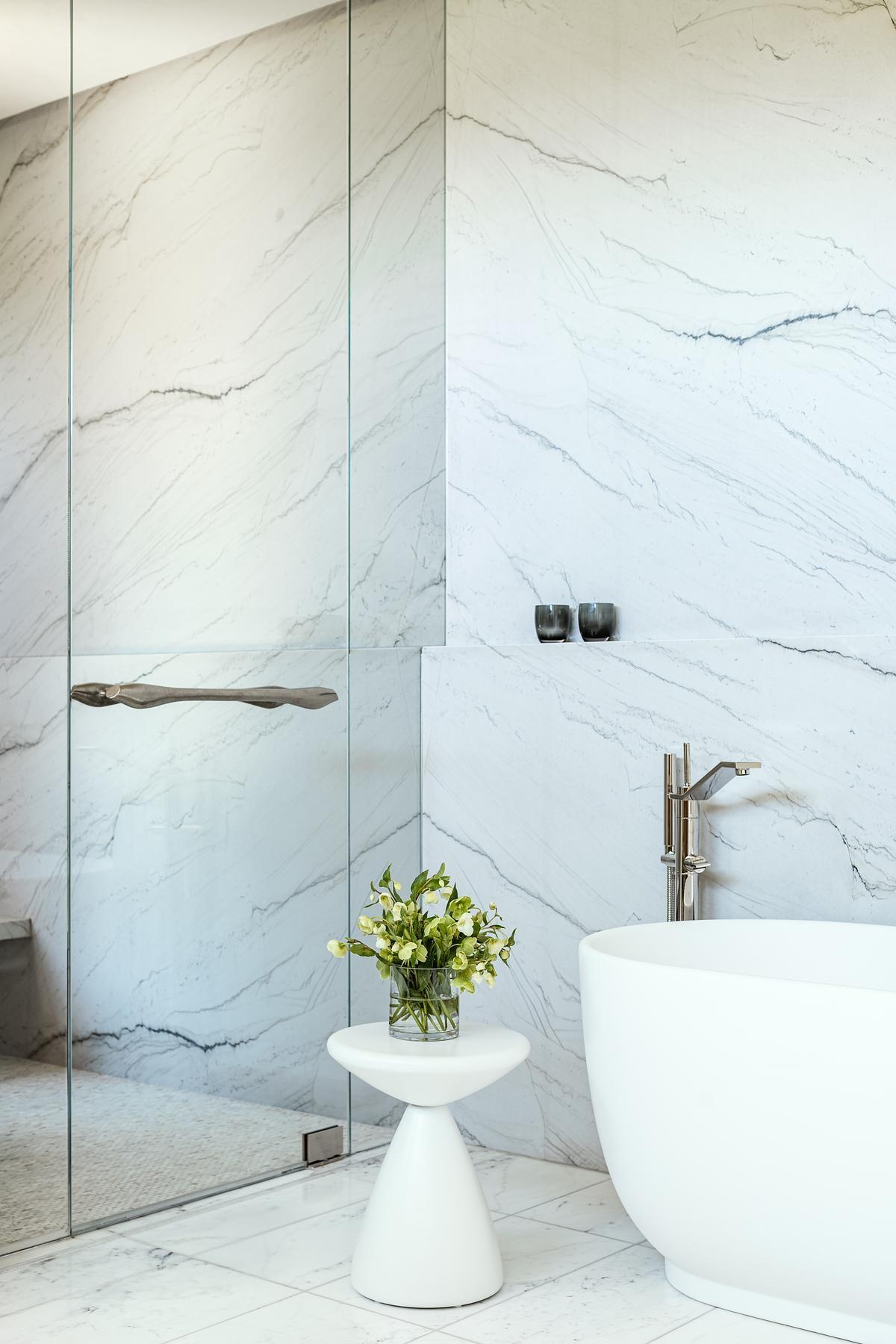 Natural materials, spa-inspired finishes, and wellness amenities including a sauna, steam room, and cold plunge create luxurious bathrooms designed for comfort and relaxation.