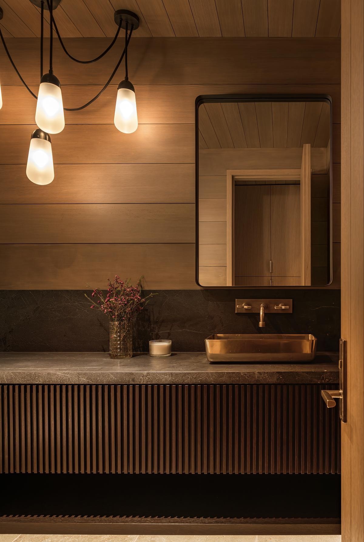Natural materials, spa-inspired finishes, and wellness amenities including a sauna, steam room, and cold plunge create luxurious bathrooms designed for comfort and relaxation.