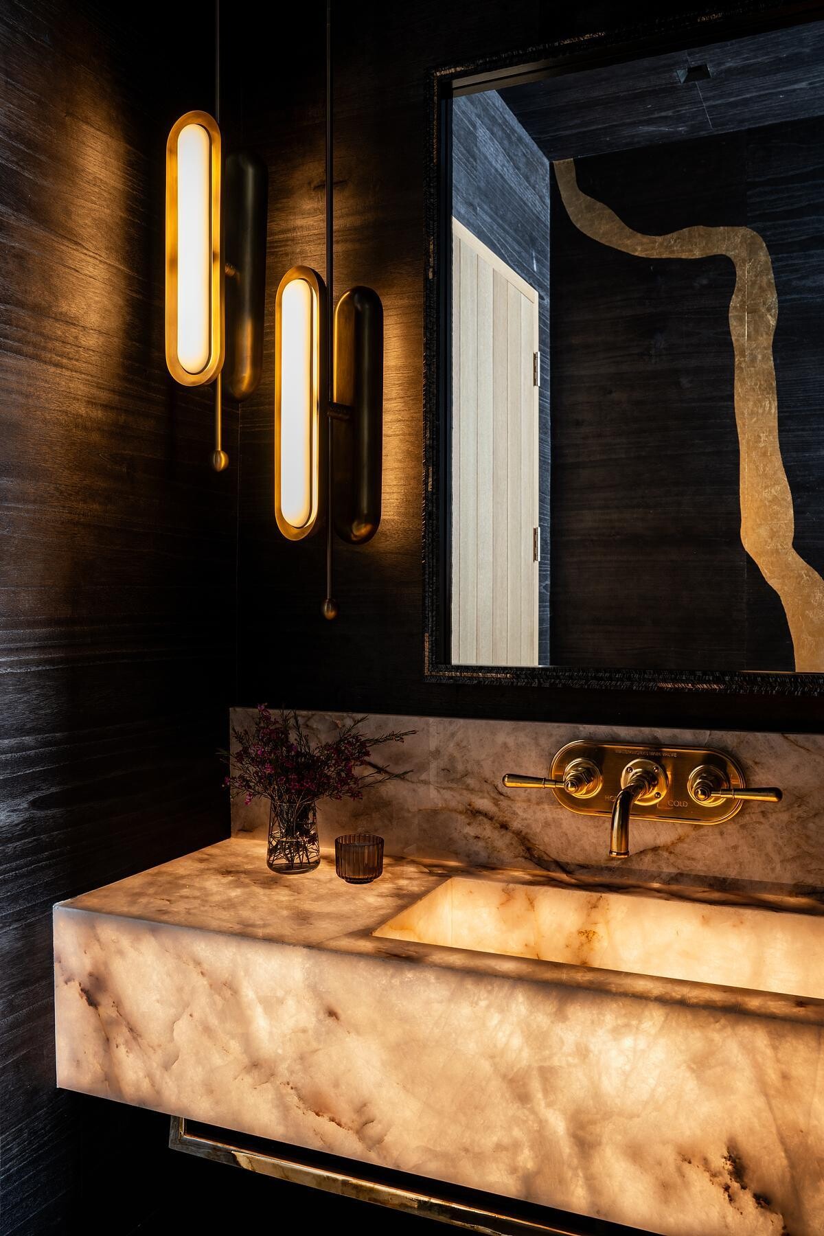 Natural materials, spa-inspired finishes, and wellness amenities including a sauna, steam room, and cold plunge create luxurious bathrooms designed for comfort and relaxation.