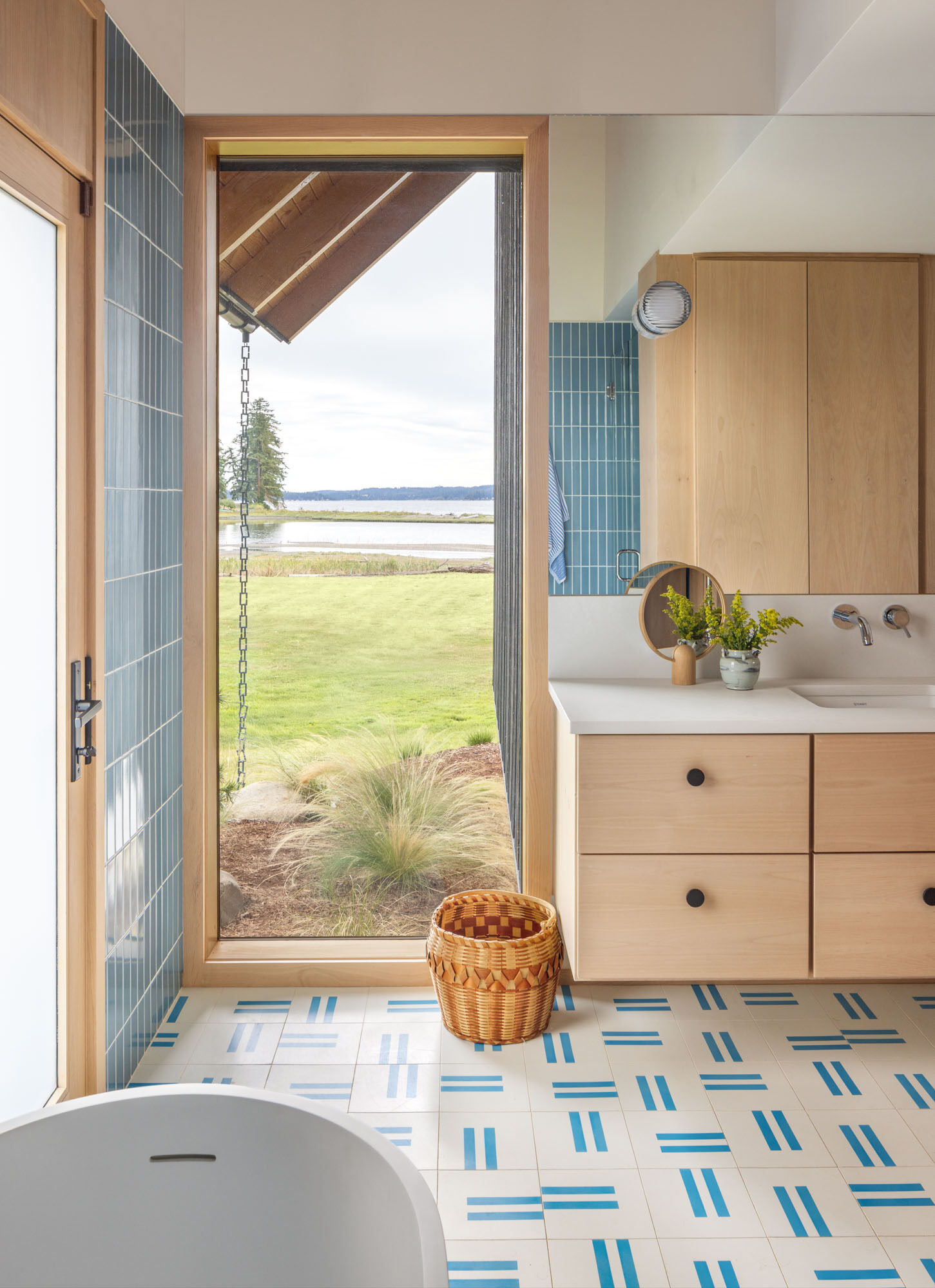 Distinct color palettes give this bathroom its own personality while complementing the home's natural material palette.