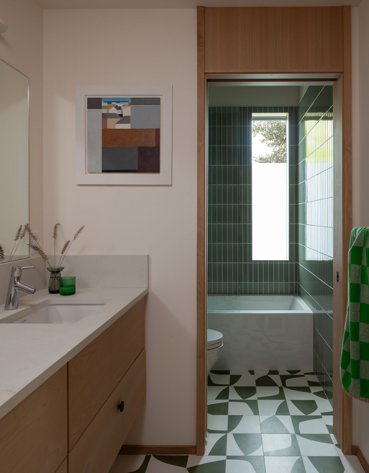 Distinct color palettes give this bathroom its own personality while complementing the home's natural material palette.