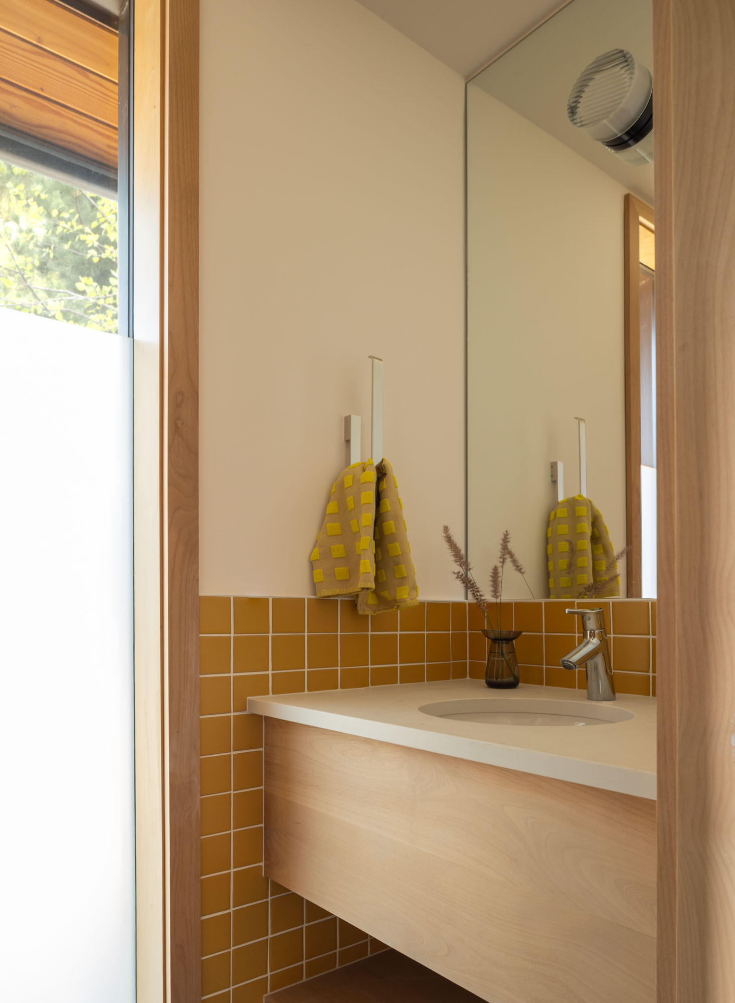 Distinct color palettes give this bathroom its own personality while complementing the home's natural material palette.