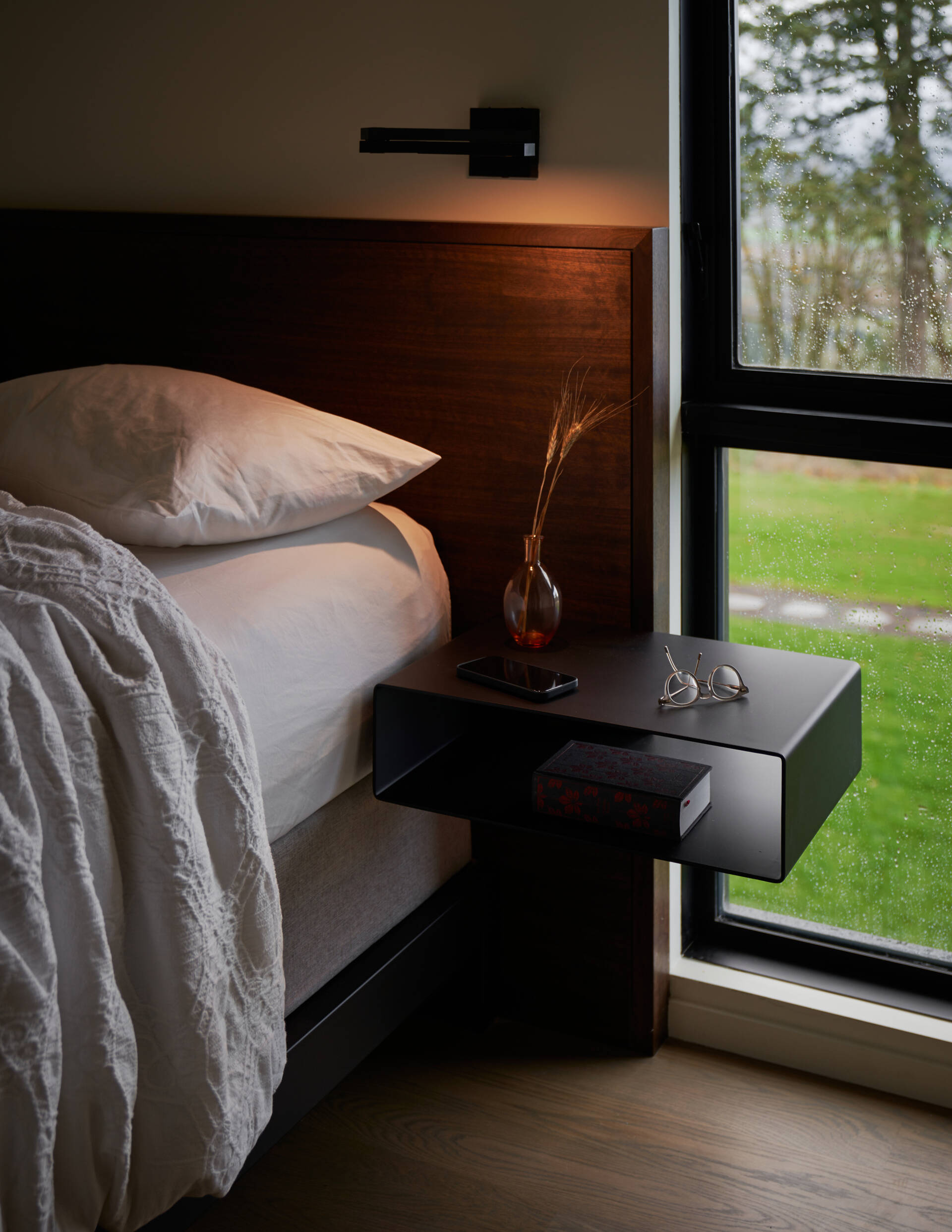 A modern bedroom with a floating bedside table.