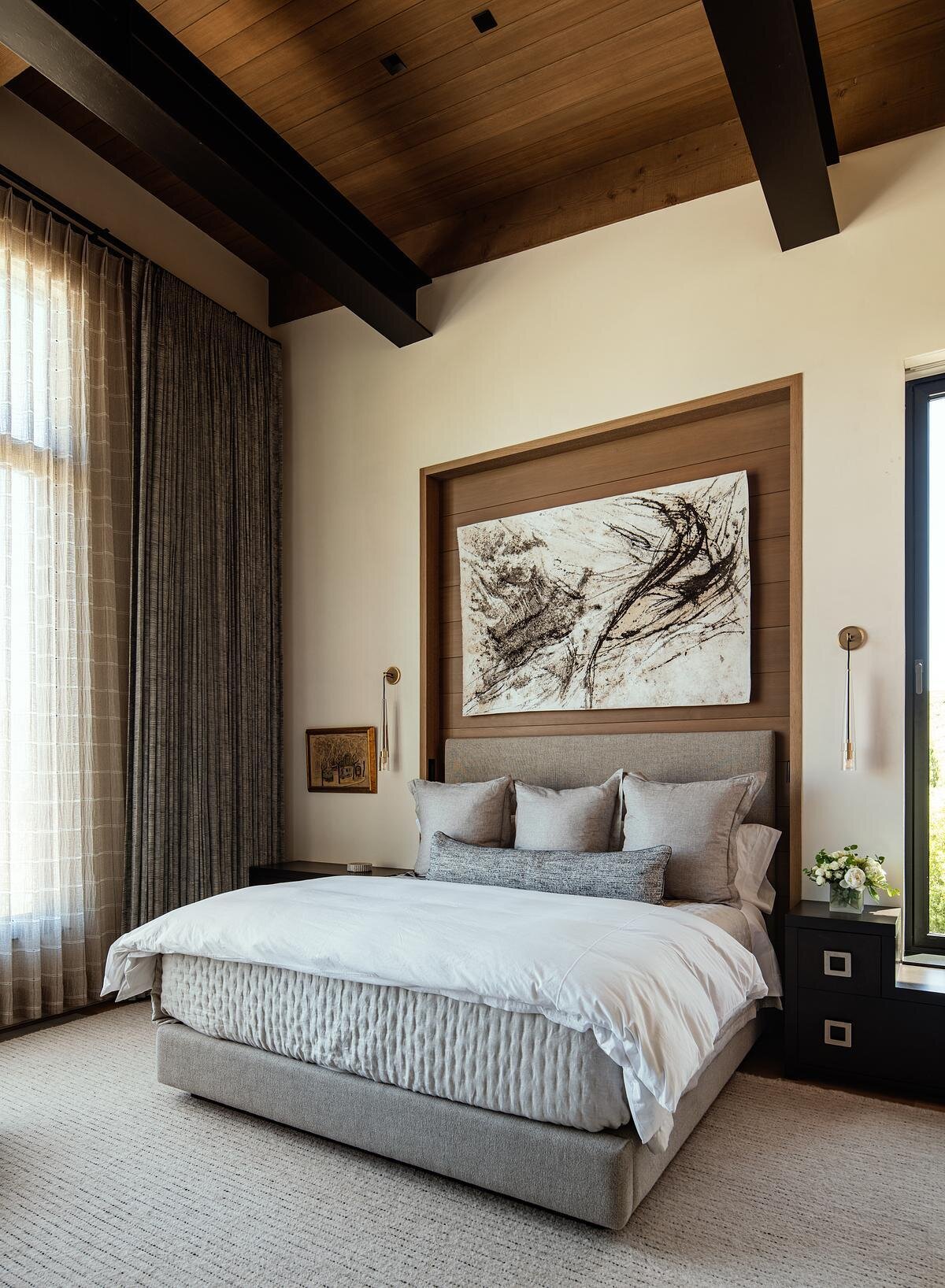 Warm timber ceilings, exposed beams, oversized windows, and layered textures give these modern bedrooms a cozy yet sophisticated feel, with mountain views becoming part of the design.