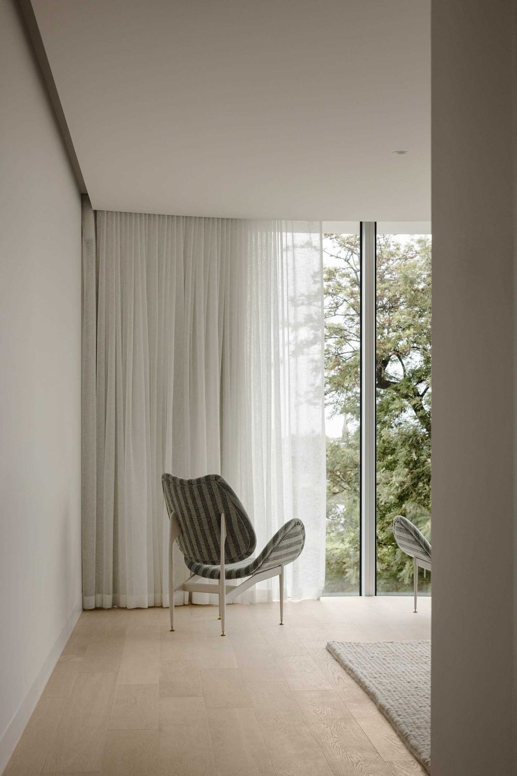 Soft curtains, natural light, and elegant finishes create tranquil bedrooms that echo the flowing forms found throughout No. 6 Sydney Street.