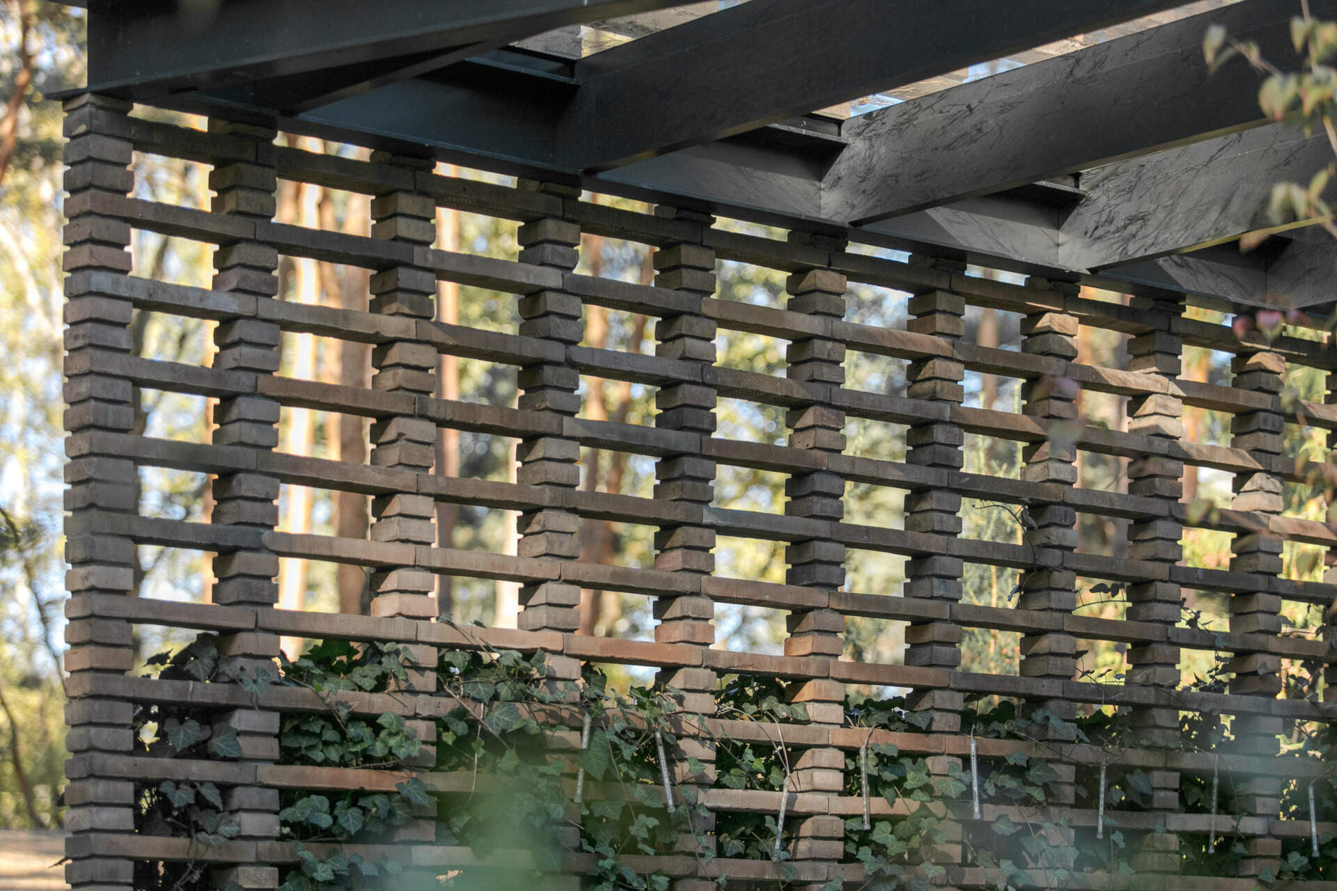 Hand-formed brickwork gives House with a Glade warmth and texture. Inspired by the bark of surrounding pine trees, the façade includes openwork sections that filter light and conceal private outdoor spaces.
