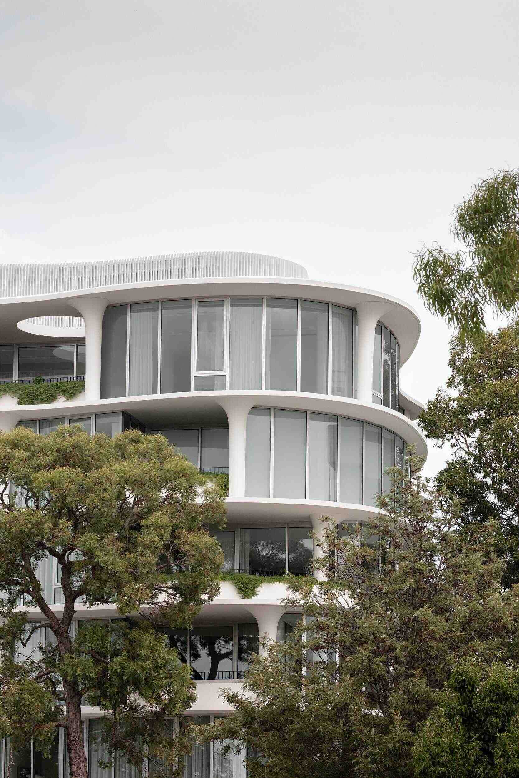 Organic curves, rippling facades, and sculpted flared columns give No. 6 Sydney Street its unique architectural identity. A striking example of contemporary residential design by Wood Marsh.