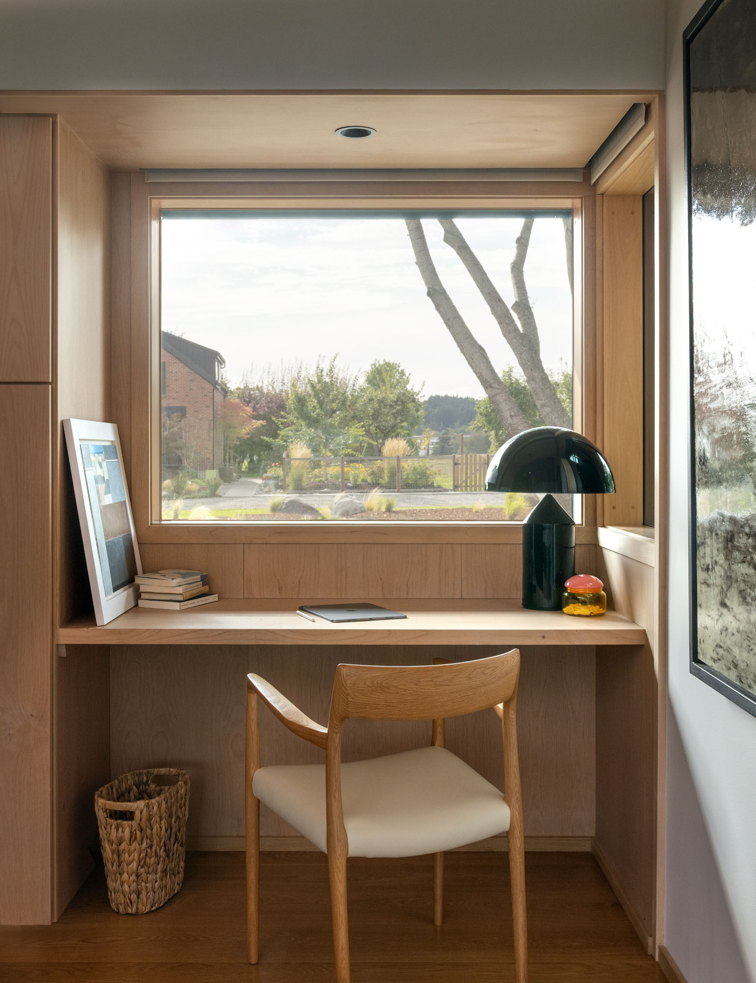 A flexible guest bedroom incorporates workspace functionality, making it ideal for visitors and remote work alike.