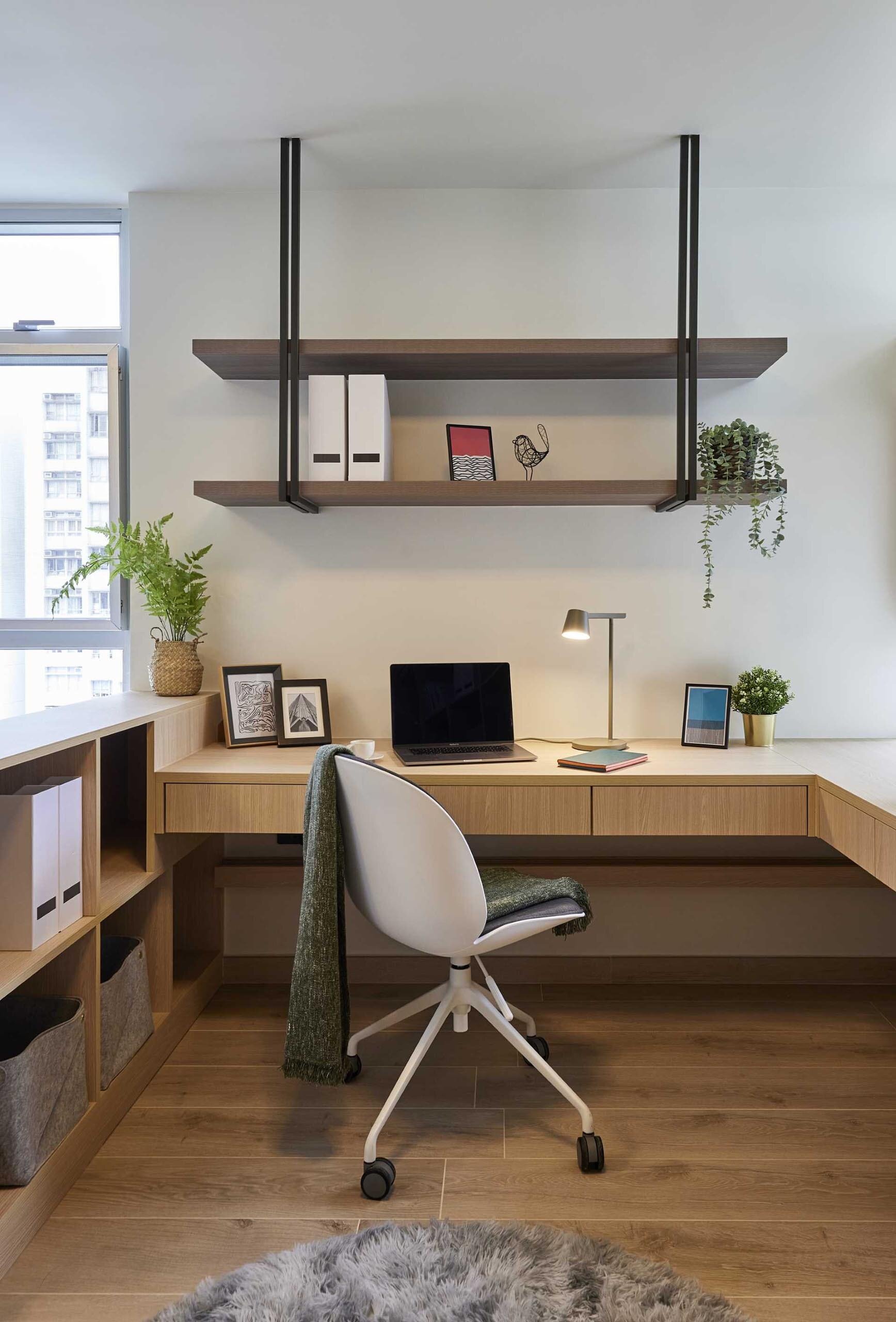 See how two small rooms were combined to create a bright bedroom and home office. This clever Hong Kong apartment is packed with smart storage and space-saving design ideas.