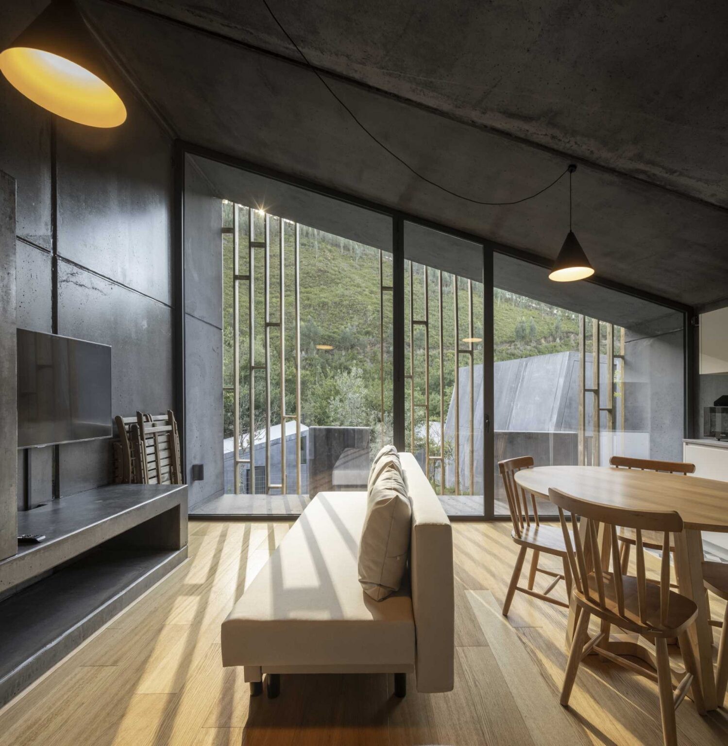 Inside these Portuguese cabins, timber floors, simple furnishings, and efficient layouts create comfortable living spaces. Each compact home includes everything needed for both short stays and year-round occupation.