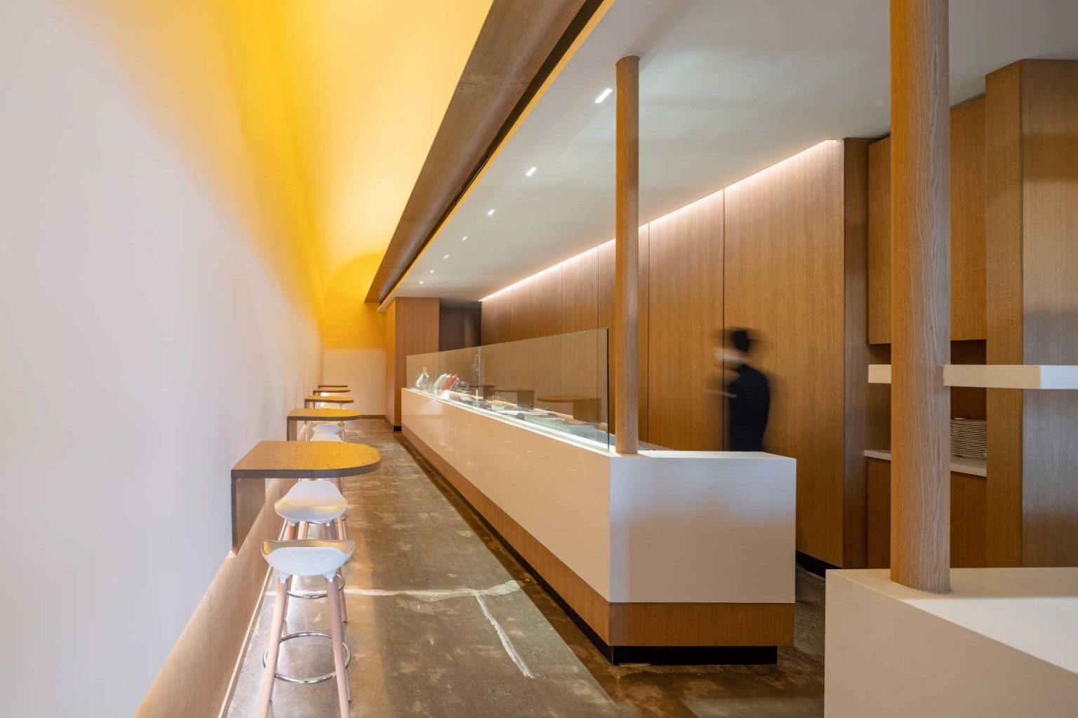 Hidden lighting behind signs, walls, and service areas creates a warm glow throughout Fuwa Fuwa Golden Square, enhancing its modern Japanese-inspired interior.