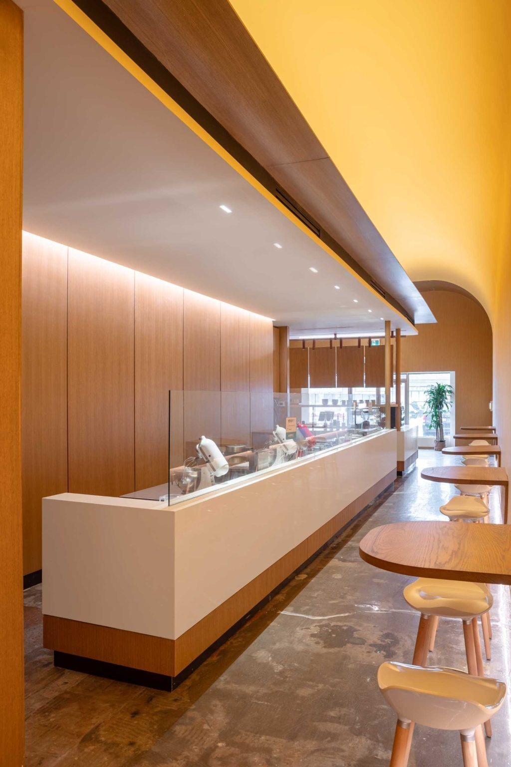 Wall-mounted tables, stools, and views of the bustling service area create an energetic cafe atmosphere inside Fuwa Fuwa Golden Square.