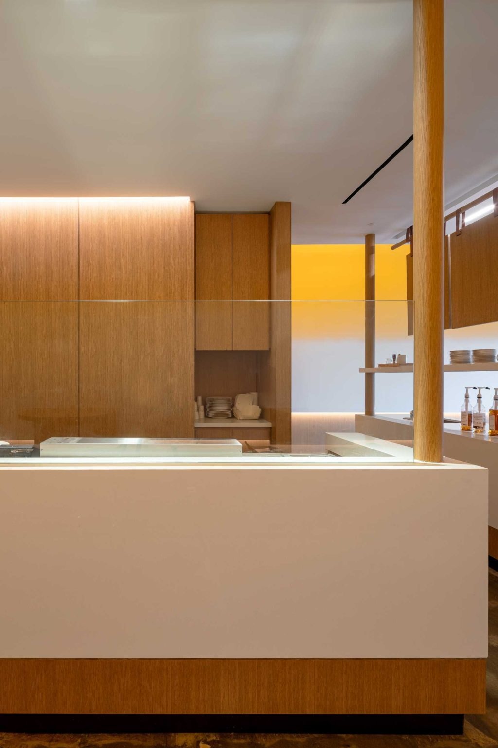 Wall-mounted tables, stools, and views of the bustling service area create an energetic cafe atmosphere inside Fuwa Fuwa Golden Square.