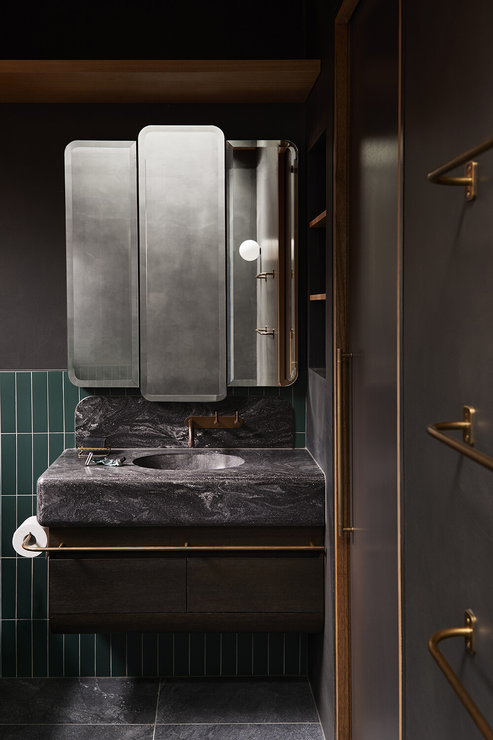 A sculpted bathroom with a microcement soaking tub and soft lighting, inspired by Japanese bathing spaces in a Melbourne home.
