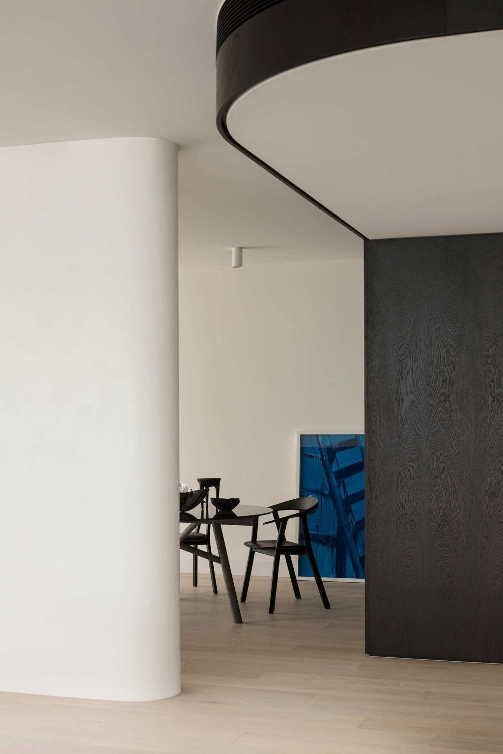 A semi-private dining space adds intimacy to the open-plan interiors of No. 6 Sydney Street, creating a refined setting for everyday living and entertaining.