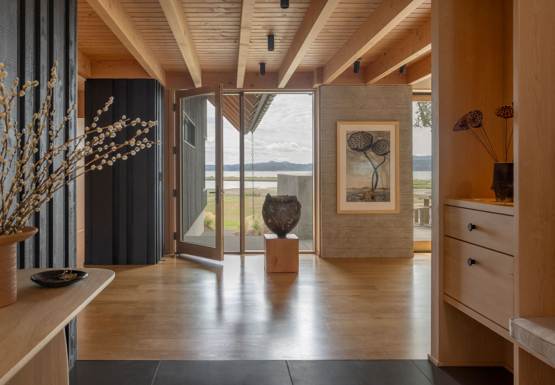 A framed waterfront view greets visitors from the entry, creating one of the most memorable moments in this Washington home.