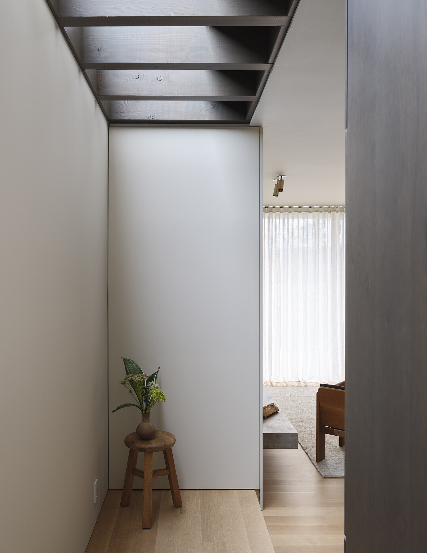 A modern staircase has natural light that shines from above.