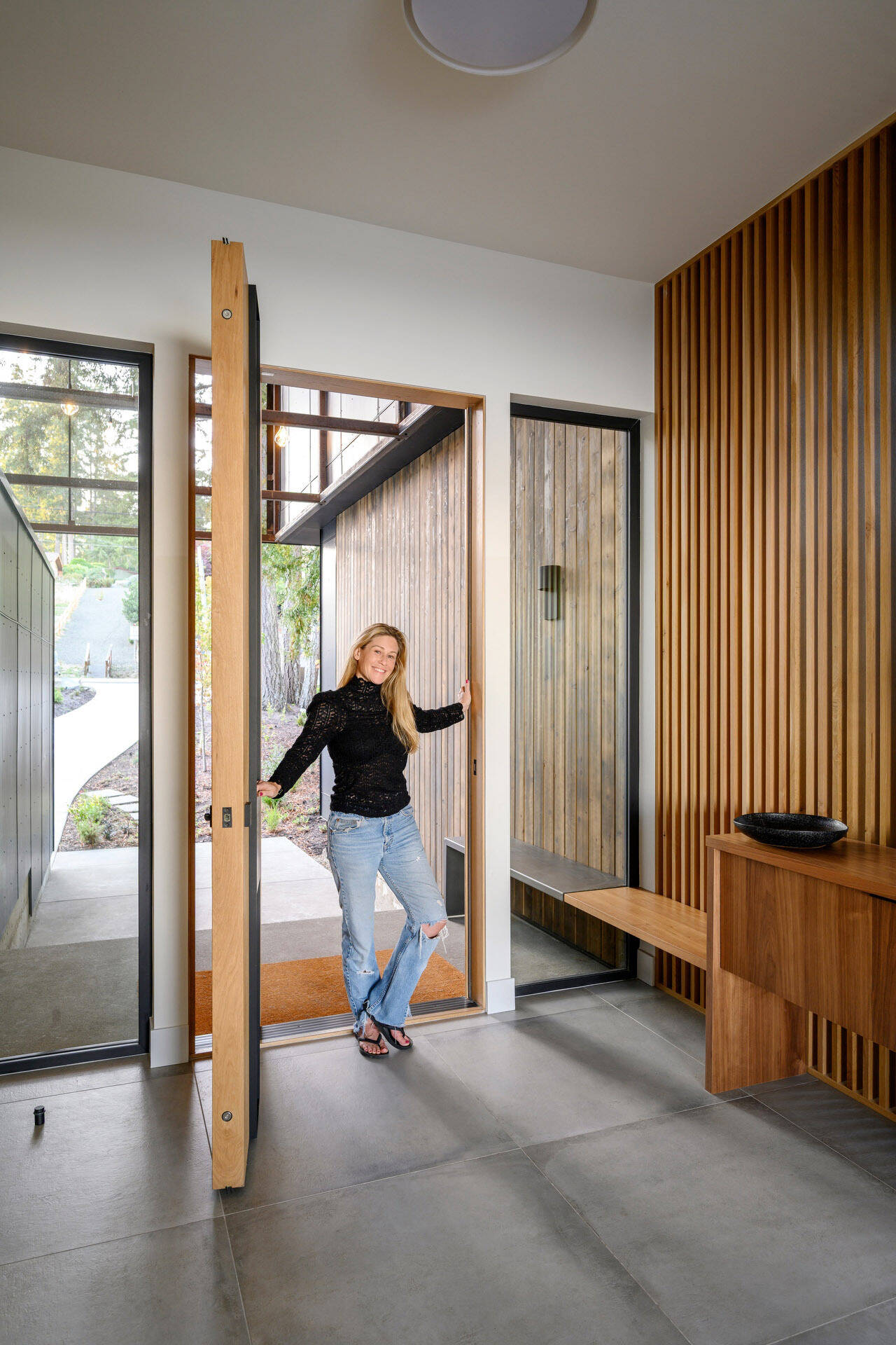 Step inside Lantern House through a light-filled entry featuring warm timber battens, a floating staircase, and beautiful modern Pacific Northwest design.