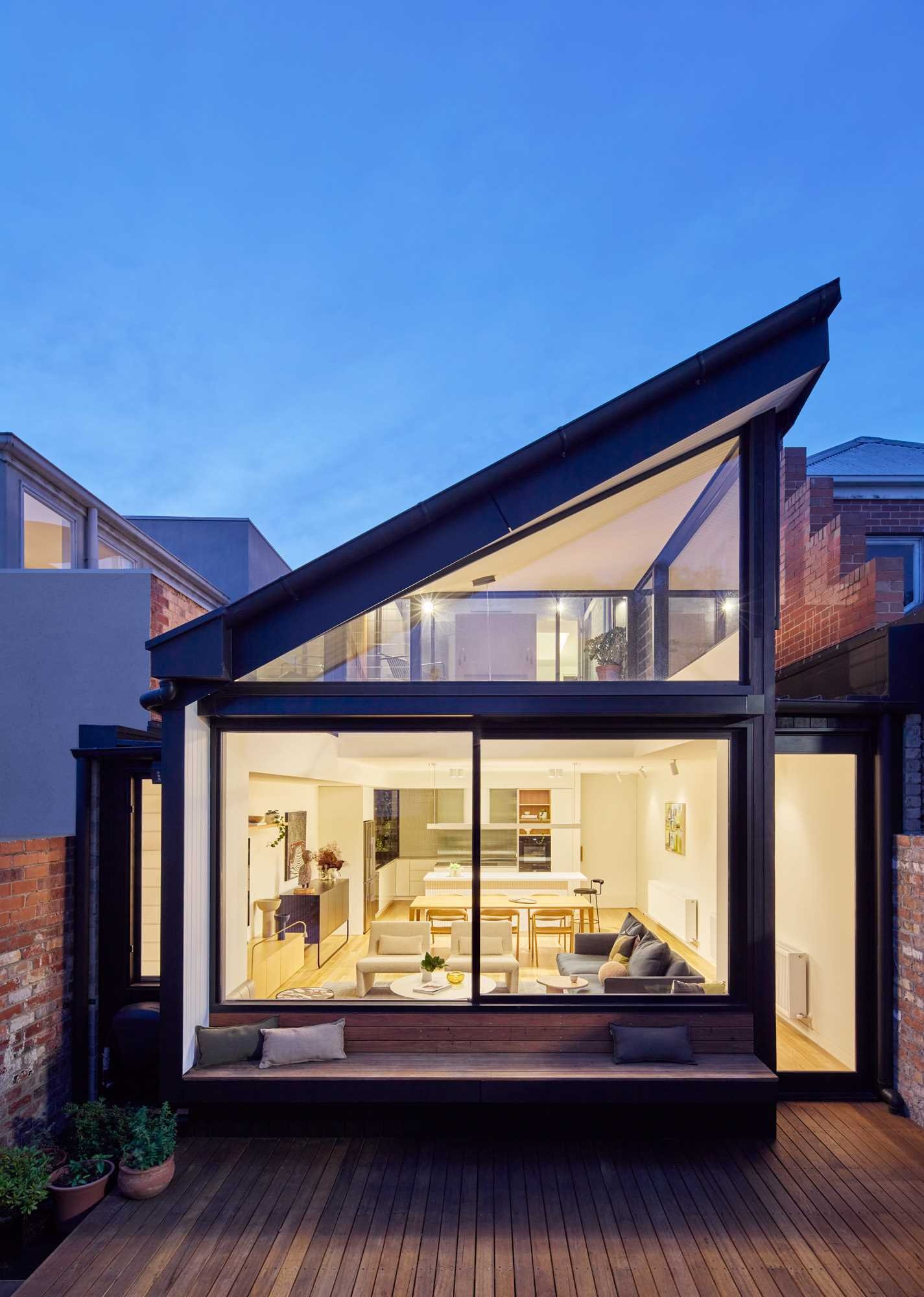 A built-in bench beneath a large sliding window creates the perfect spot to enjoy the courtyard while connecting indoor and outdoor living.