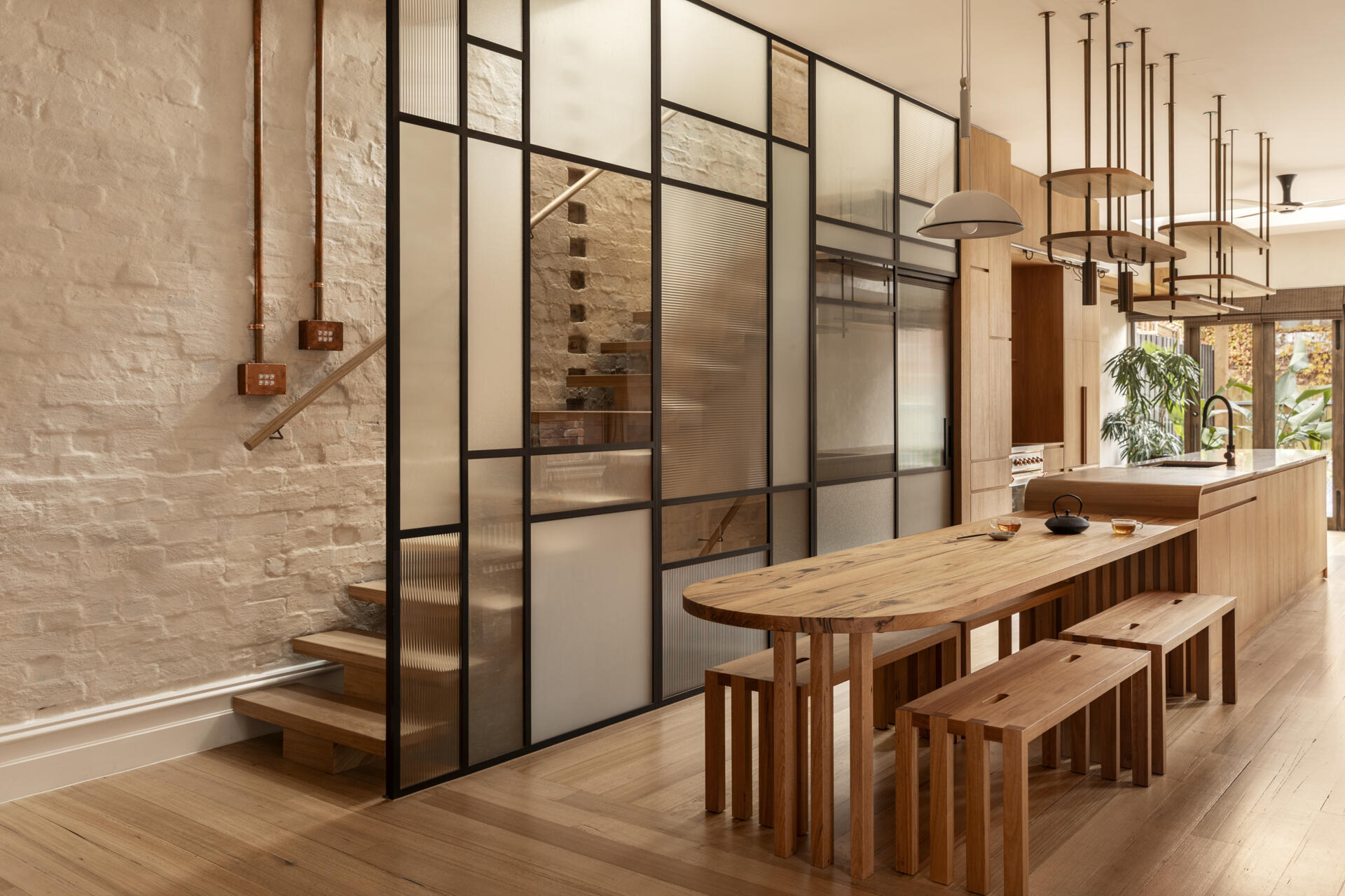 Haiku House in Brunswick East by Steffen Welsch Architects and Kim Kneipp transforms an 1890s terrace into a light-filled family home blending Victorian arches, shoji-inspired details, and natural materials.