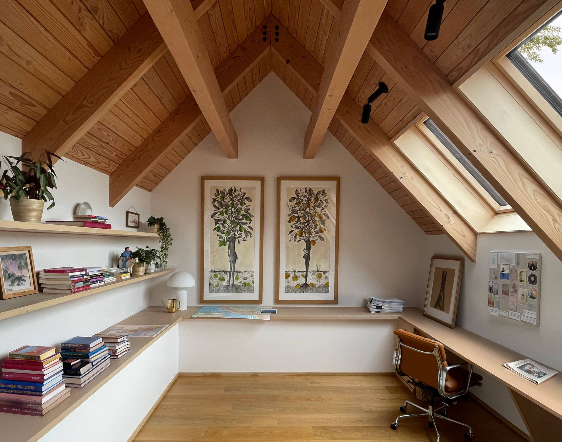 An elevated loft provides flexible office and storage space while overlooking the home's dramatic interior volumes.