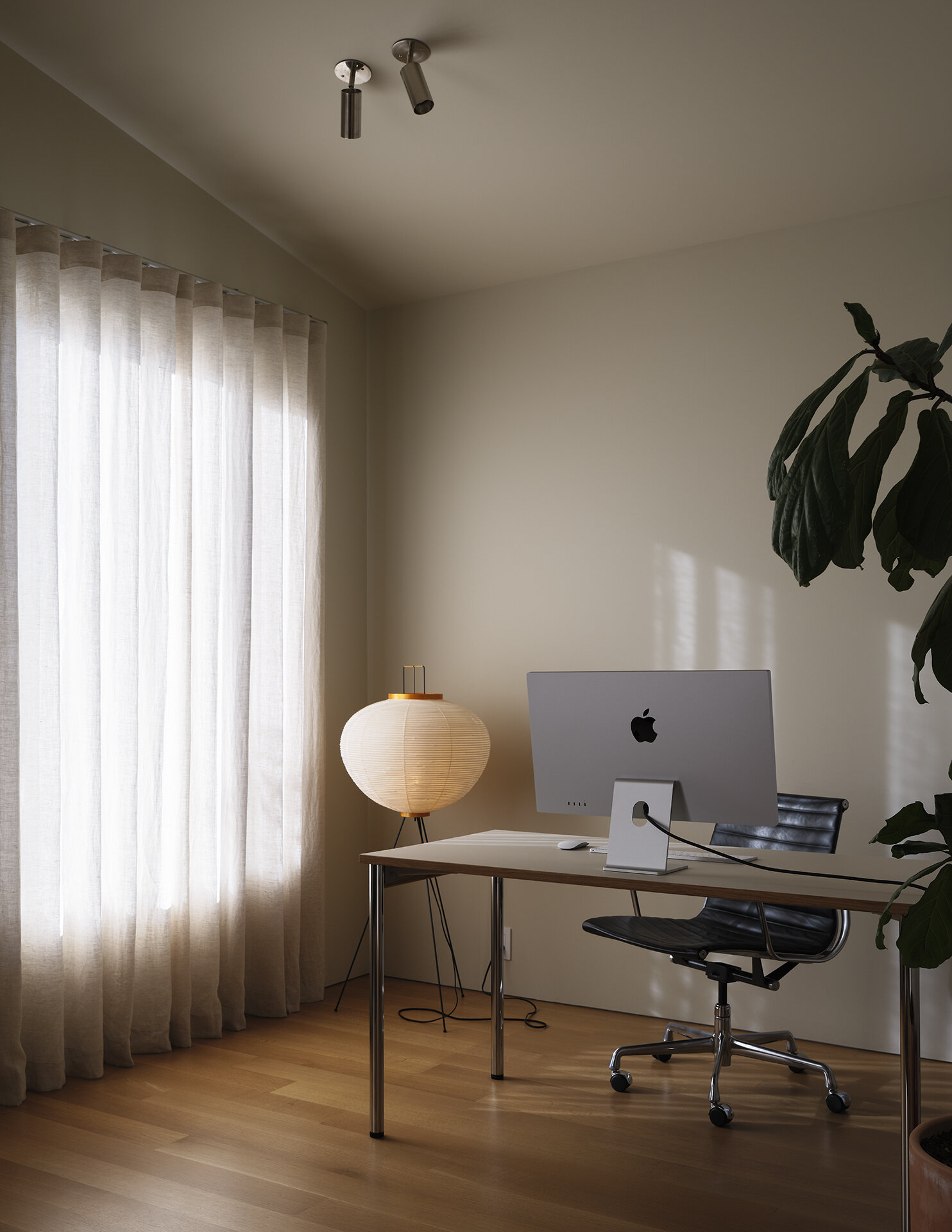 This upstairs bedroom doubles as a bright and functional home office designed for remote work.