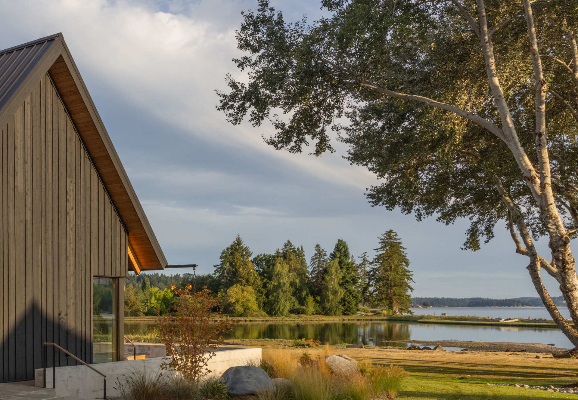 Thoughtful landscaping helps create privacy while opening beautiful sightlines toward the waters of Dyes Inlet on Washington's Kitsap Peninsula.