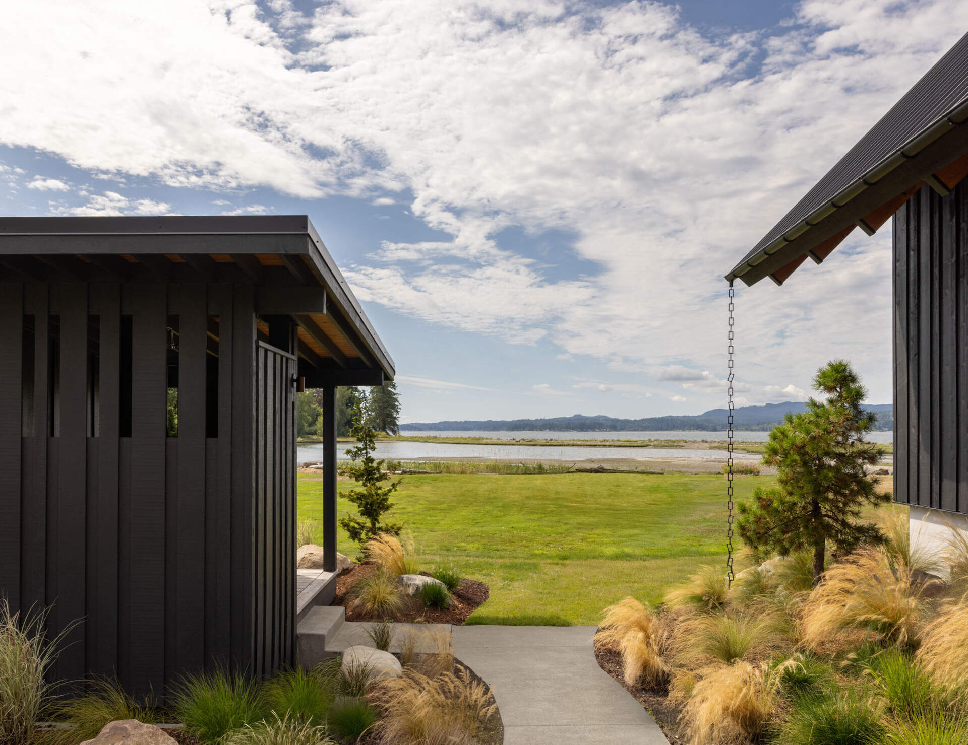 Thoughtful landscaping helps create privacy while opening beautiful sightlines toward the waters of Dyes Inlet on Washington's Kitsap Peninsula.
